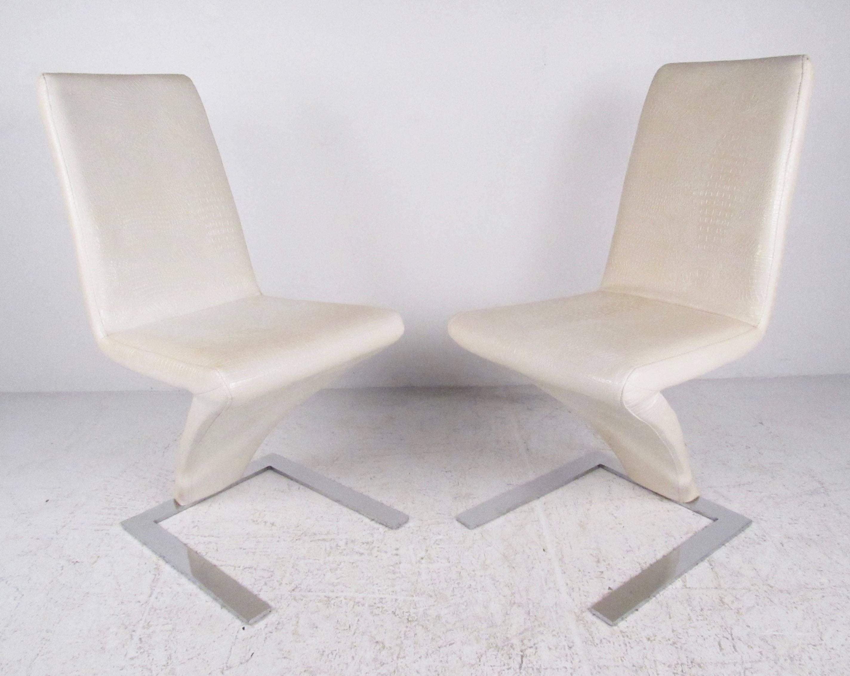 This stylish pair of contemporary modern side chairs feature faux skin upholstery, sturdy cantilever base, and comfortable high back design in the style of Verner Panton. Please confirm item location (NY or NJ).