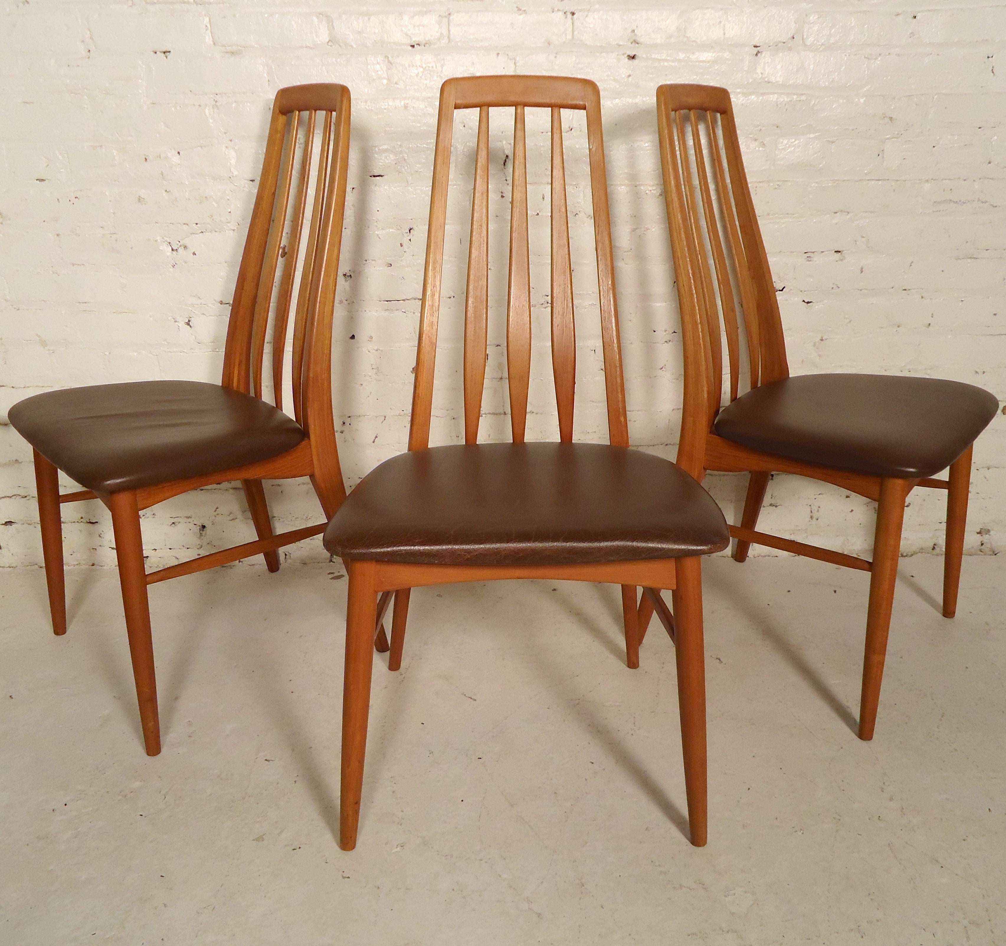 Set of six gorgeous Danish modern dining chairs by Koefoed. Long, sleek slat backs, leather seats, tapered legs and stretchers. Three seats have been recovered, three remain in a worn leather. Color matches, no rips, with beautiful wear and
