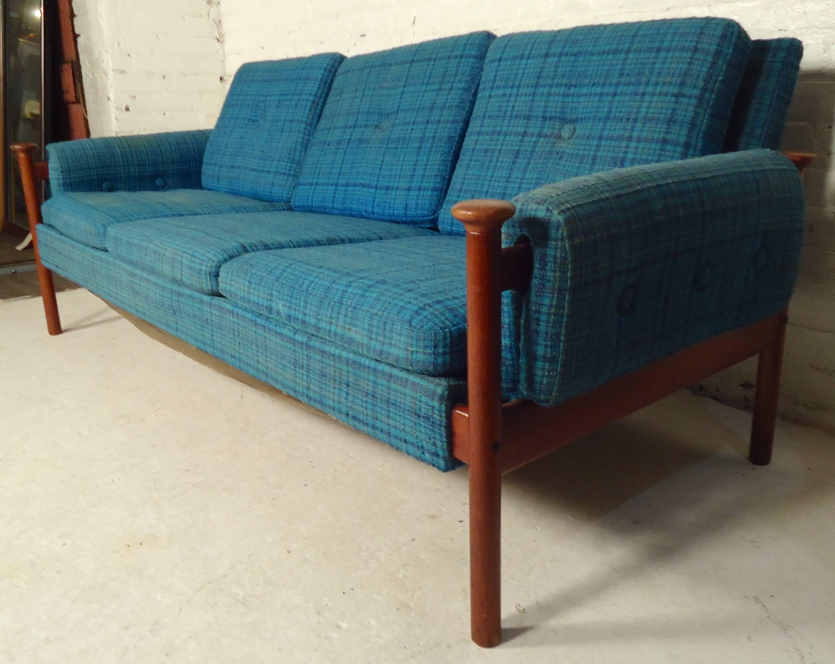Long Mid-Century Modern sofa with teak frame. Three-seat cushioning, upholstered back, unique arm posts add to the Scandinavian Modern appeal of this Finn Juhl style sofa. 

(Please confirm item location-NY or NJ-with dealer).
  