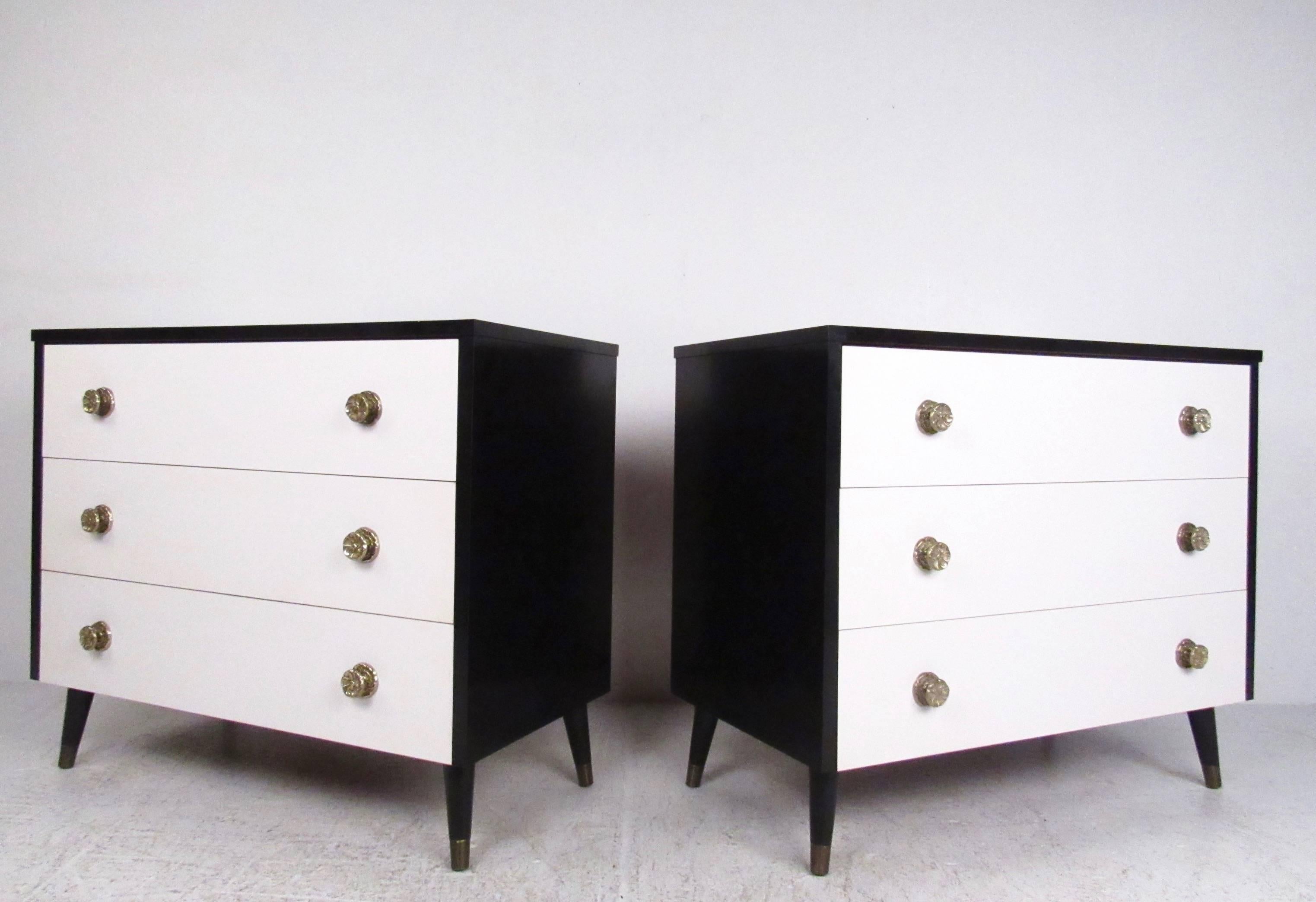This stylish pair of vintage dressers feature a beautiful two tone lacquer finish with ornate brass pulls. Mid-Century Italian style three-drawer dressers make a unique black and white addition to any bedroom, tapered legs, formica style tops, and