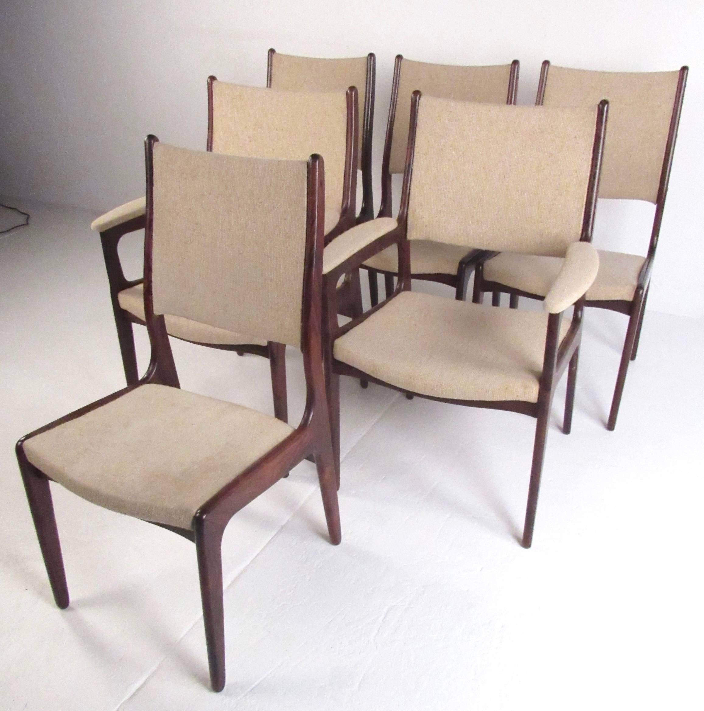 This stylish set of six vintage rosewood dining chairs feature rich hardwood finish and upholstered high back seats. Comfortably padded, the Mid-Century Danish modern design of the set make these the perfect addition to any dining set. Please