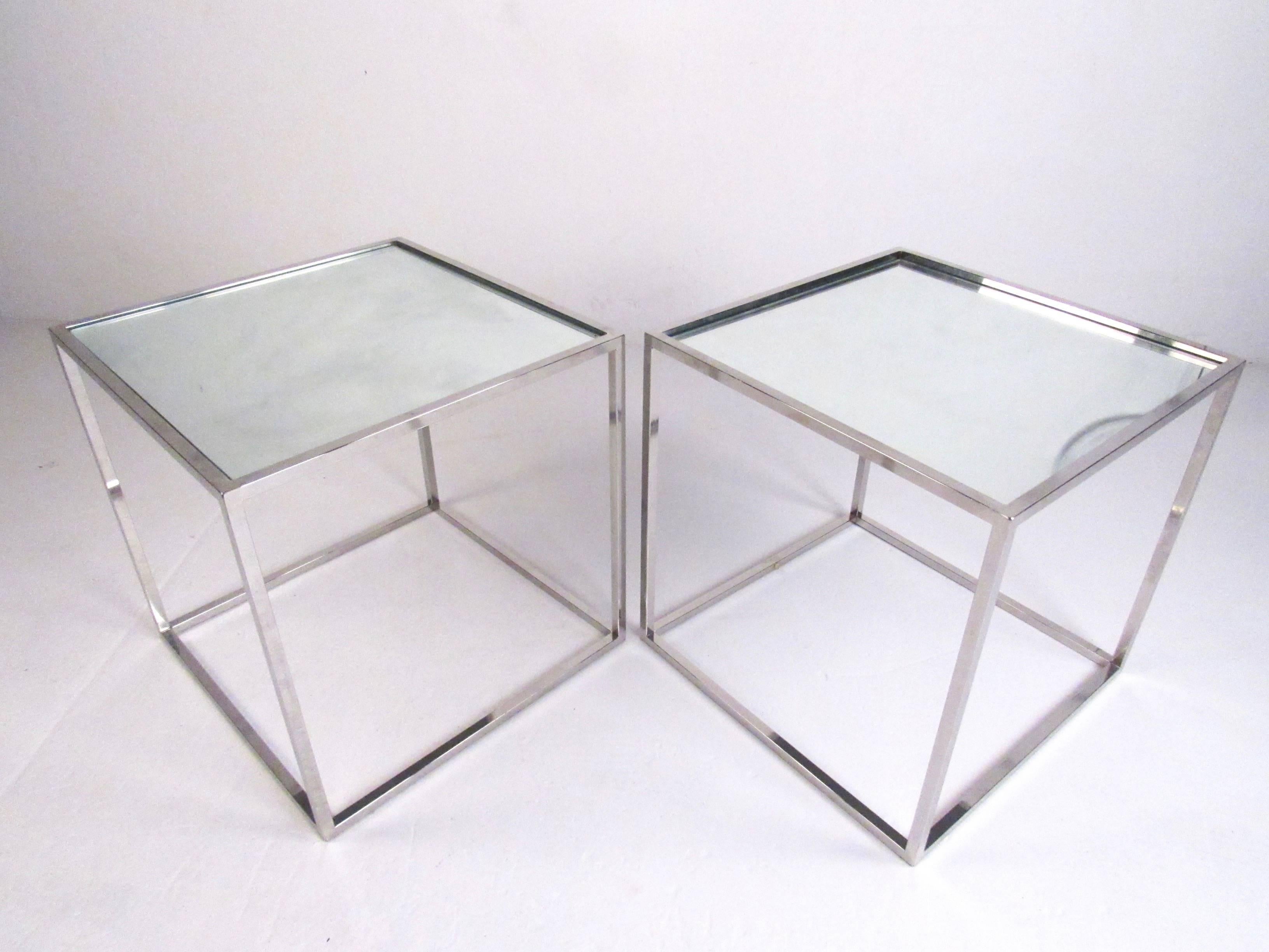 This stylish pair of cubist end tables feature stylish vintage chrome construction with a mirrored glass tabletop. The elegant simplicity of this mid-century pair of tables make them the perfect modern addition to any interior. Please confirm item