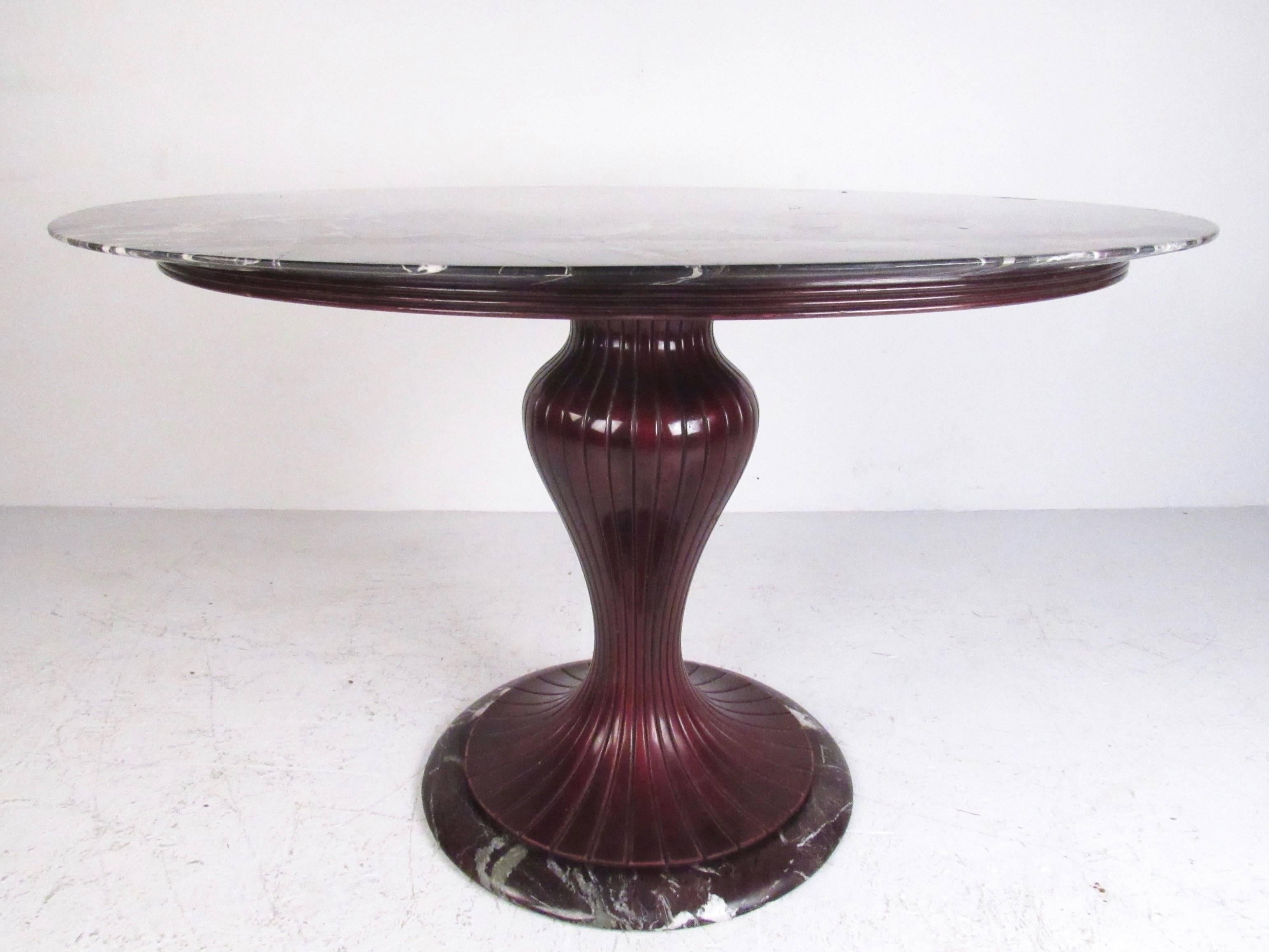 This stylish Italian pedestal table features a circular marble top set on an ornately tapered pedestal base. Mid-Century style make this an excellent center table for an entryway and an impressive addition to home or business. Please confirm item