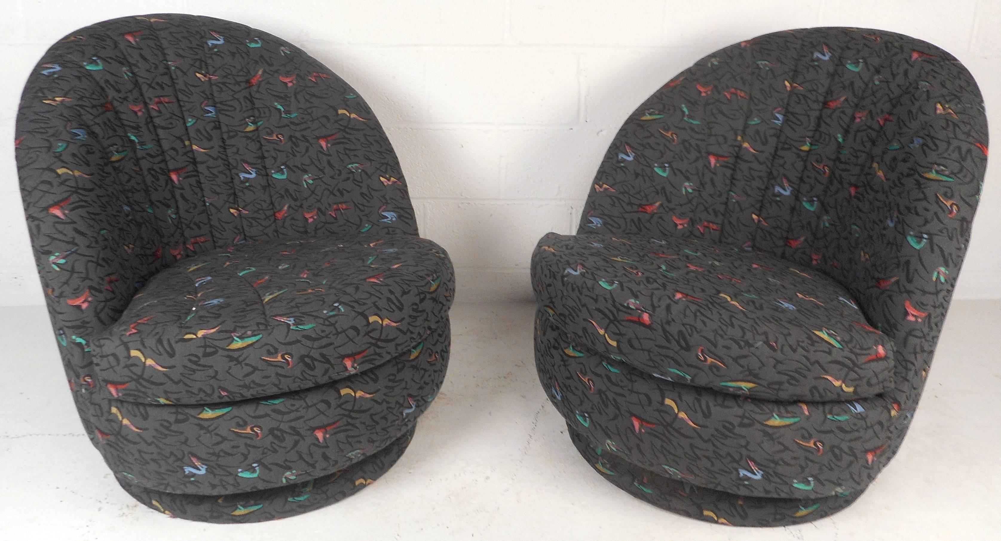 This beautiful pair of vintage modern lounge chairs feature unique shell shaped back rests thick padded cushions. The comfortable design offers the ability to swivel with ease. Elegant multicolored plush upholstery covers the entire chair making