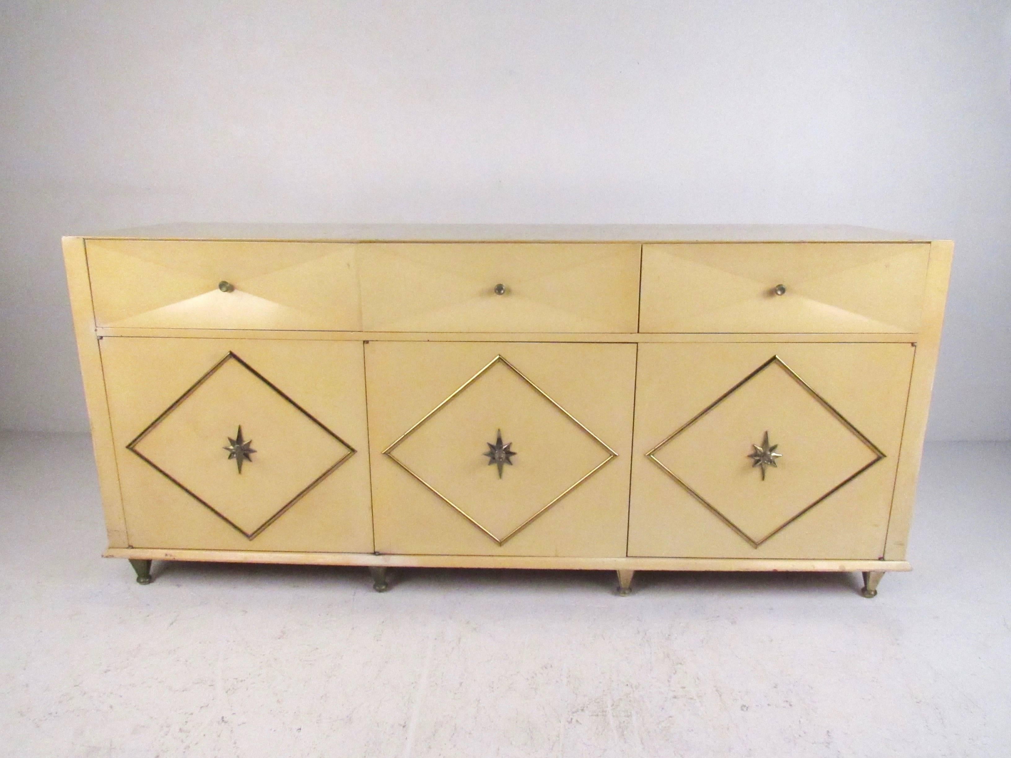 This pair of Mid-Century Hollywood Regency style bedroom dressers make a stylish vintage addition to any interior. Vintage lacquer finish is wonderfully complimented by unique brass pulls, ornate metal legs, and decorative trim. The matched boho