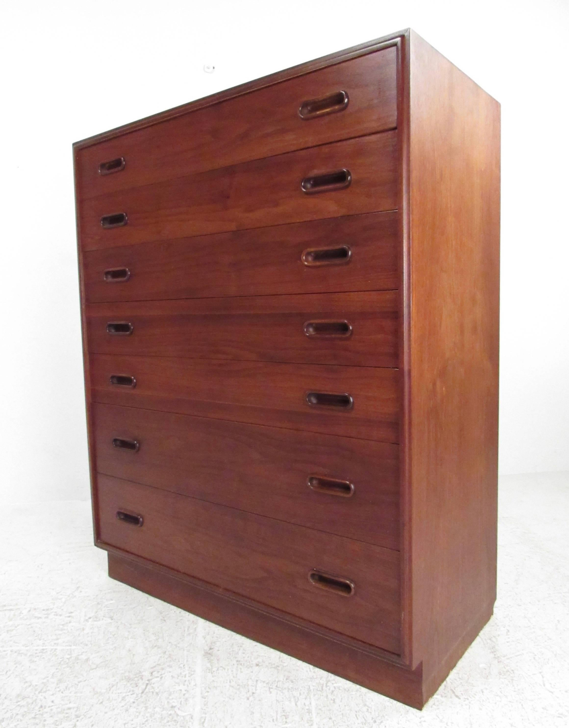 This stylish Scandinavian Modern dresser features seven graduated drawers for storage, dovetail construction, and rich vintage finish. Classic Mid-Century design makes this chest of drawers the perfect addition to any interior. Please confirm item