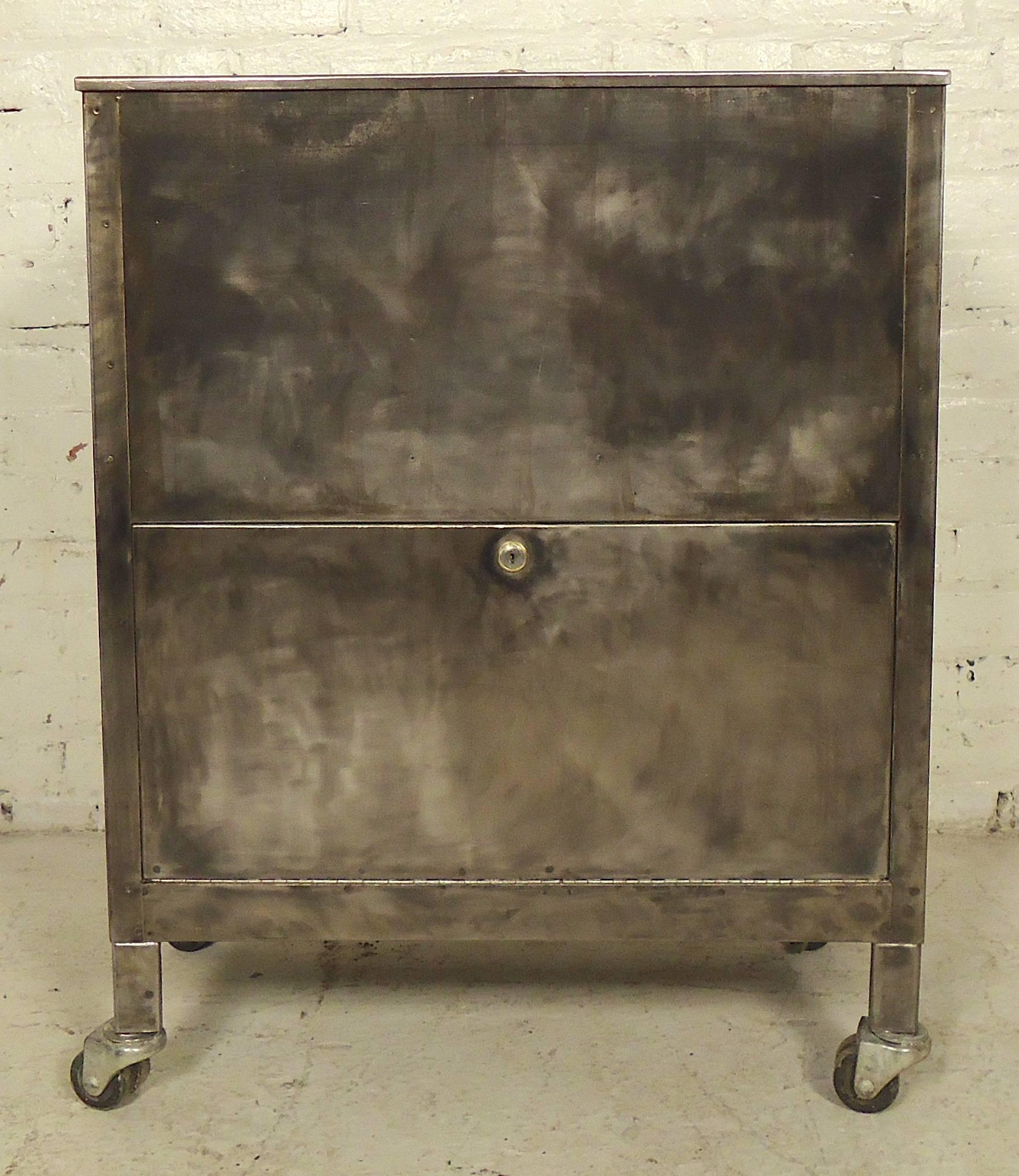Vintage metal rolling cart with Dual cabinets, refinished in a bare metal style. Could be used as a unique modern dry bar.
Top cabinet: 24