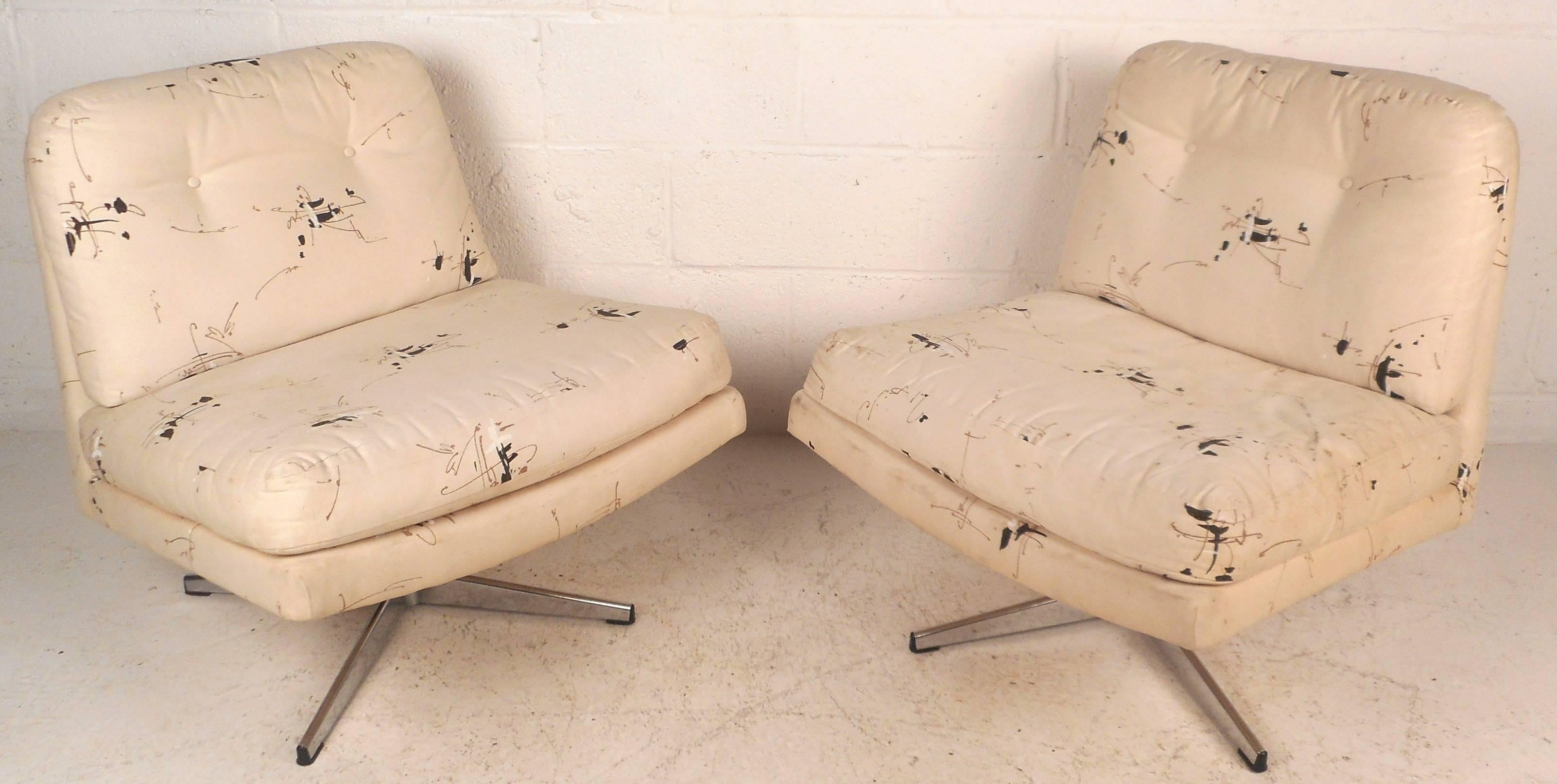 This gorgeous pair of vintage modern lounge chairs feature a slipper design with wide seating and the ability to swivel. Thick padded cushions and original tufted upholstery add to the allure. Unique mid-century pair of lounge chairs ensure comfort