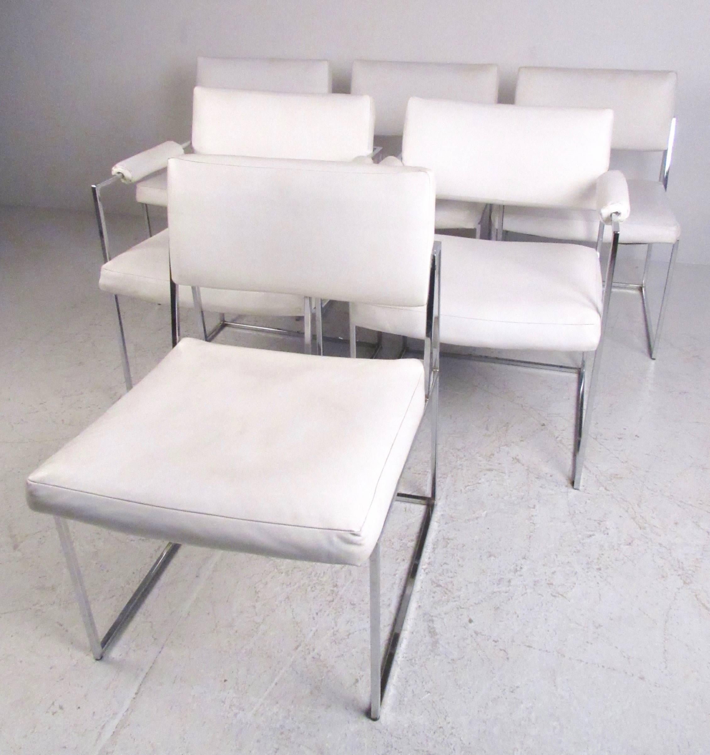This stylish set of six chrome and vinyl dining chairs offer wide and well cushioned seats, comfortable upholstered seat backs, and a pair of matched arm chairs. The vintage modern Milo Baughman style design makes an impressive addition to any