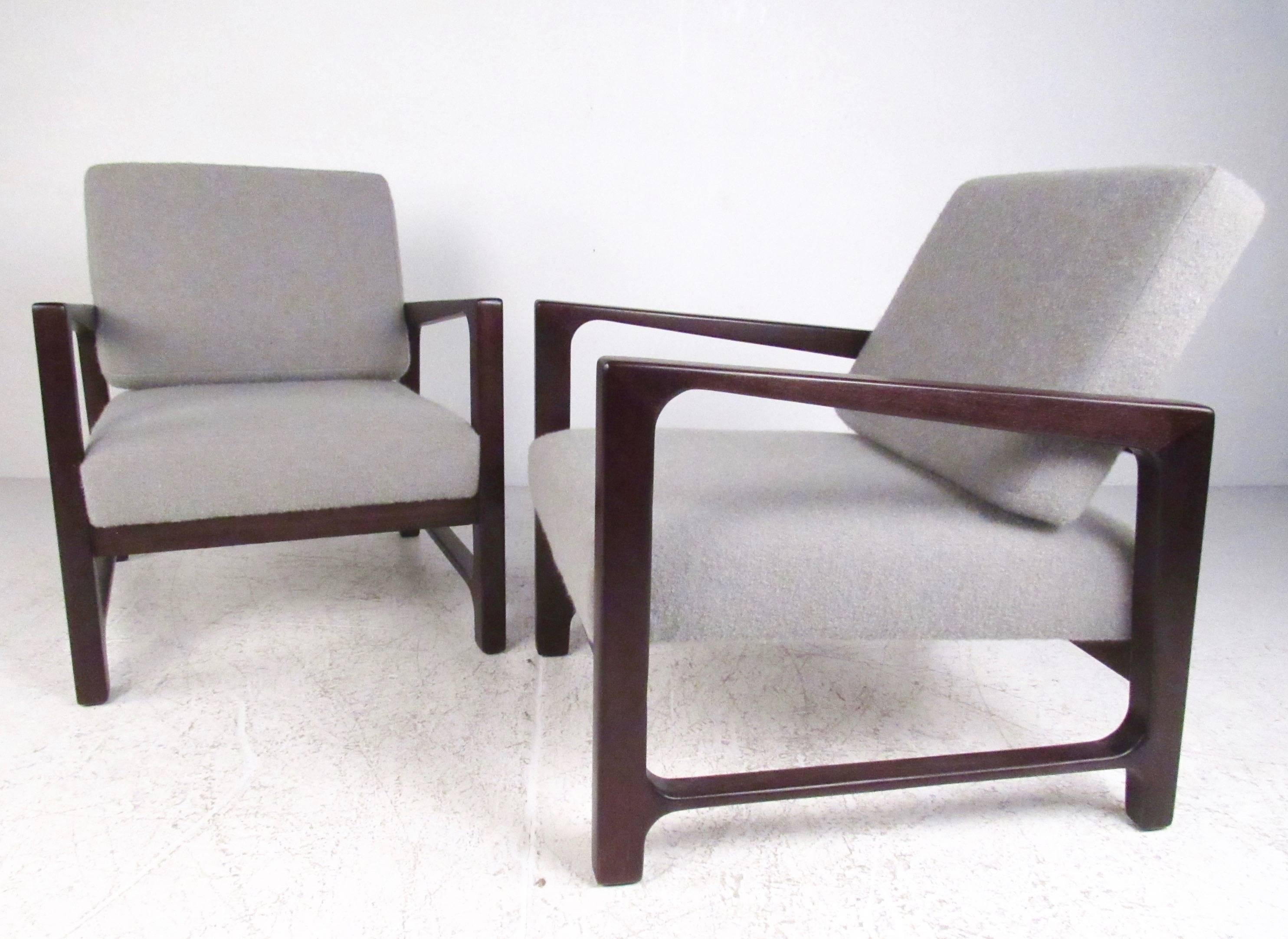 This beautiful matching pair of Harvey Probber lounge chairs feature uniquely sculpted rosewood frames with plush upholstered seating. Unique lines and cutaway hardwood seat back add to the iconic mid-century style of this set of lounge chairs,