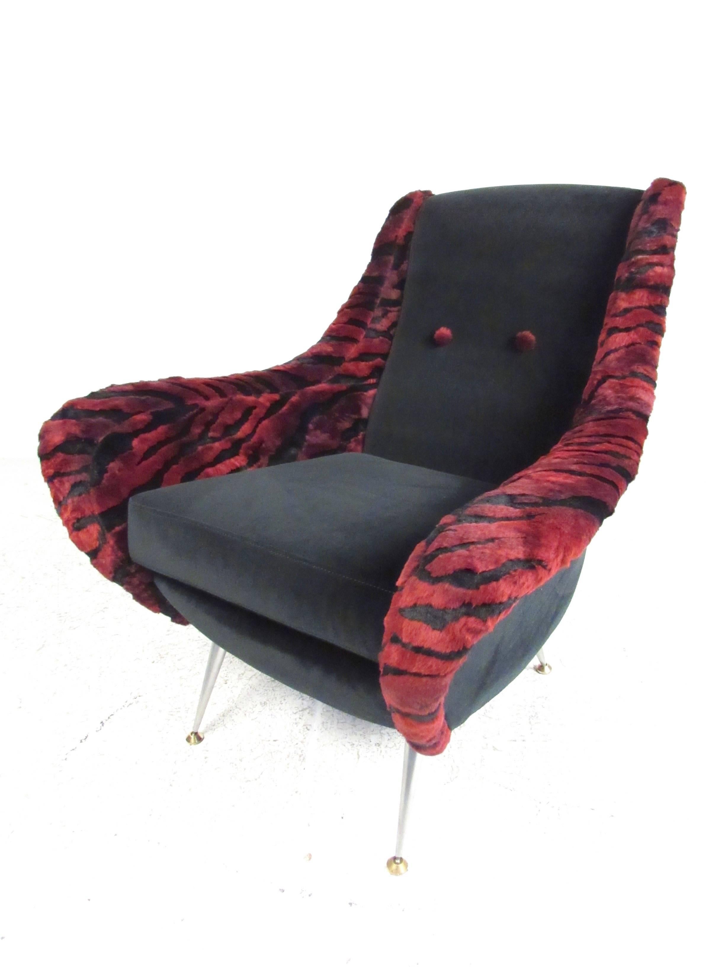 This sleek and stylish pair of Italian modern lounge chairs feature tapered aluminium legs with unique two-tone upholstered. Plush tufted fabric features funky tiger print trim, while the sculpted back and arm rests add to the style and comfort of