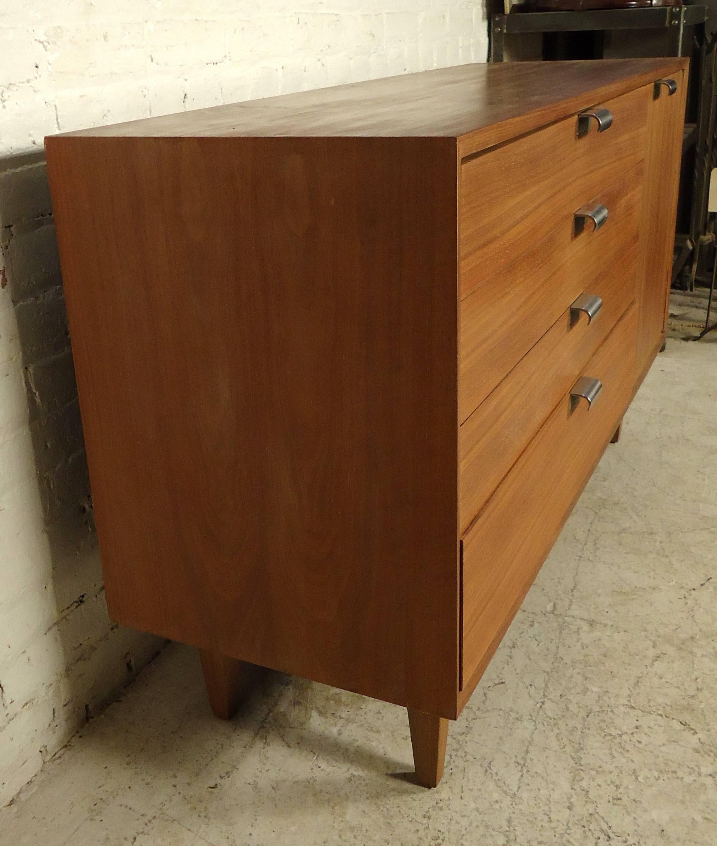 This beautiful vintage-modern server by George Nelson features rich walnut grain, four spacious drawers, a side cabinet with shelving, on a set of sturdy legs.

Please confirm item location (NY or NJ).