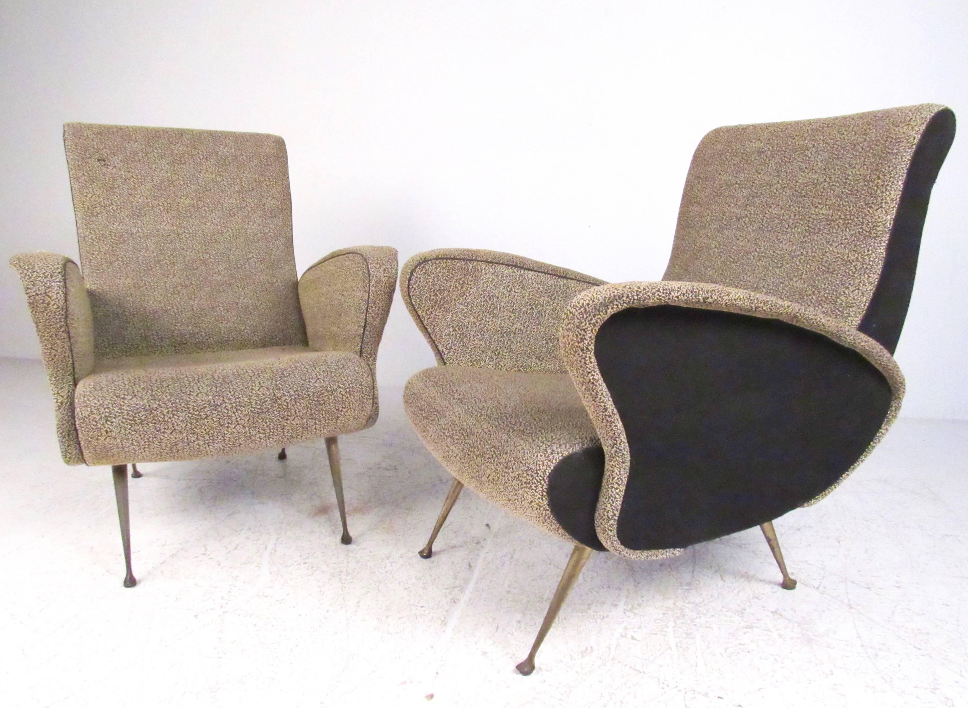 This stylish pair of Italian modern lounge chairs feature sculpted frames with vintage upholstery and unique tapered brass legs. Two-tone fabric adds to the stylish lines of this Gio Ponti style armchairs. Please confirm item location (NY or NJ).