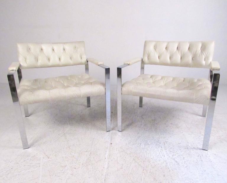 This stylish Mid-Century Modern pair of lounge chairs feature tufted vinyl upholstery and heavy chrome frames. Iconic Harvey Probber style design offers spacious seating proportions and comfortably padded seats armrests. Please confirm item location