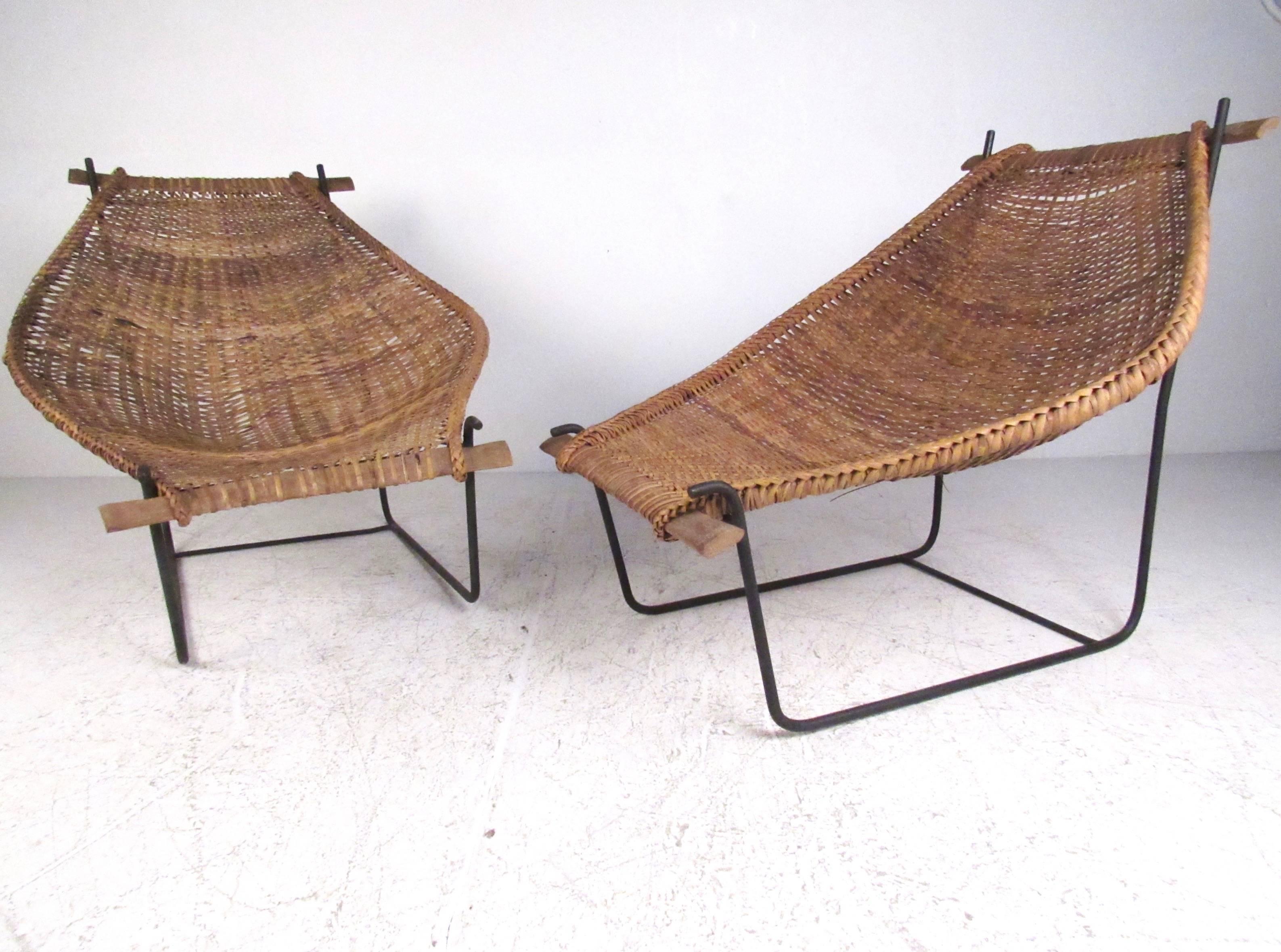 This stylish pair of wicker and iron cocoon chairs feature unique and comfortable design while making an impressive Mid-Century addition to any interior. Please confirm item location (NY or NJ).