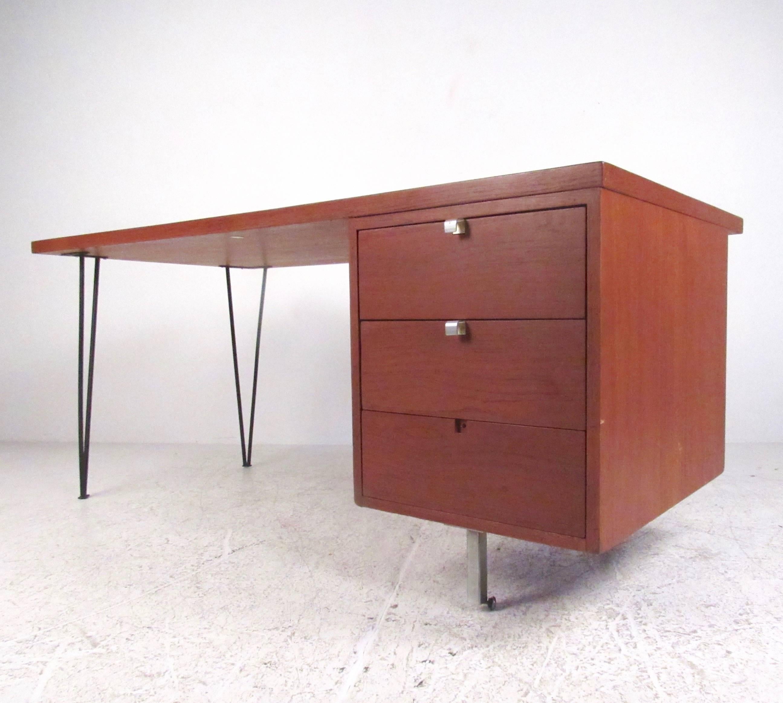 This stylish Mid-Century desk designed by George Nelson for Herman Miller offers three drawers and a spacious hardwood work space ideal for home or business office. This stylish table has been modified with hairpin legs and offers modern design for