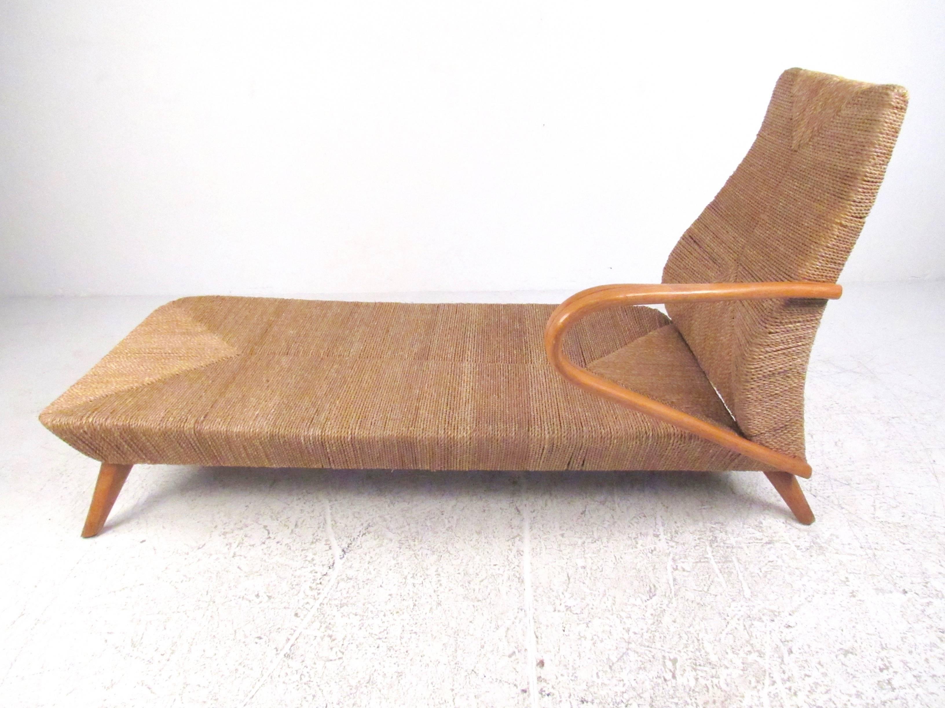 This stylish Italian style Mid-Century lounge features woven paper cord seats, sculpted arms, tapered legs, and a wonderful mix of style and comfort. This impressive and sought after single arm chaise longue chair makes a memorable seating addition