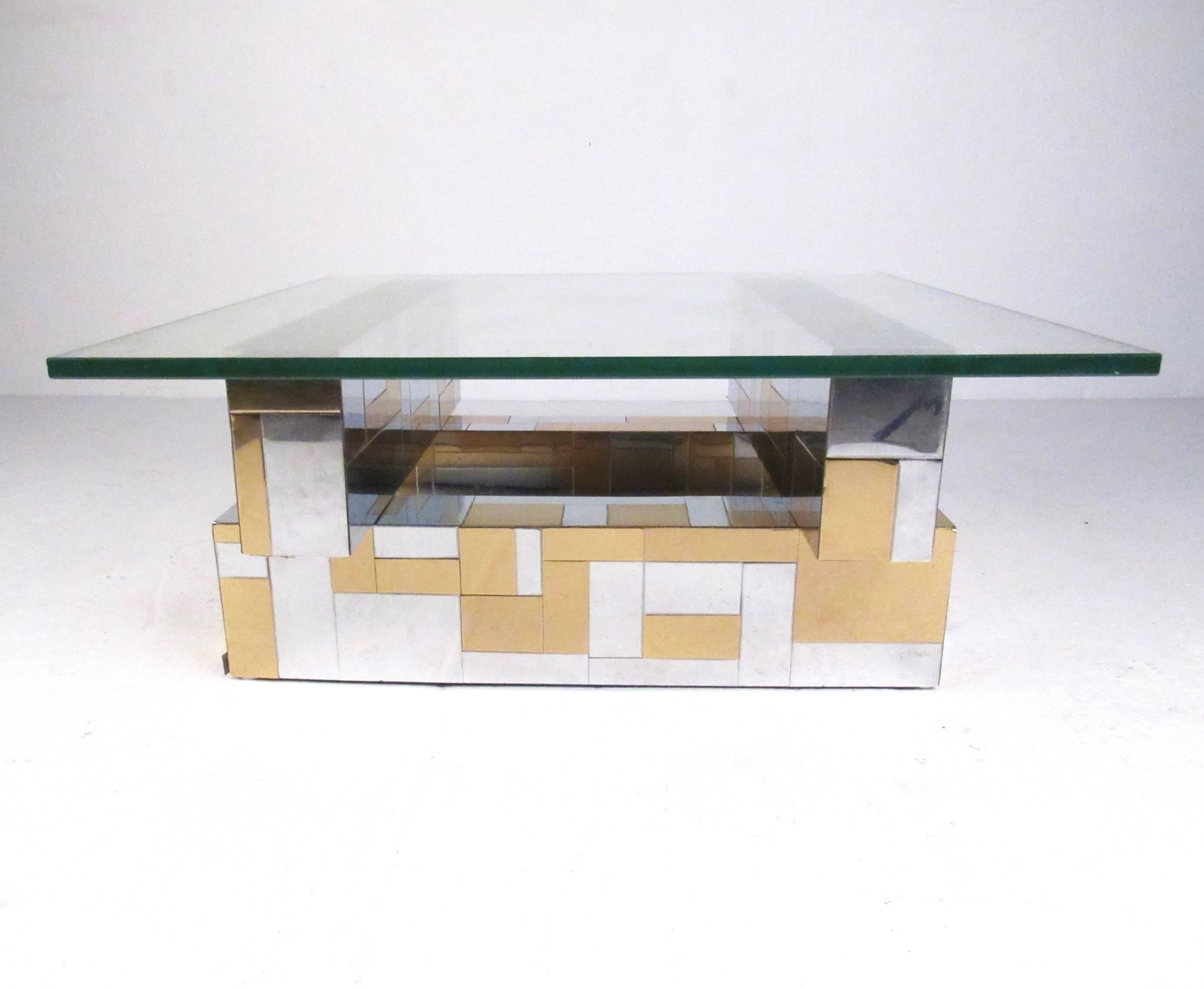 This stylish Mid-Century Modern Paul Evans coffee table features his iconic Cityscape design with patchwork chrome and brass finish. Thick glass tops a stylish four piece base and makes an impressive center table in any seating area. Please confirm
