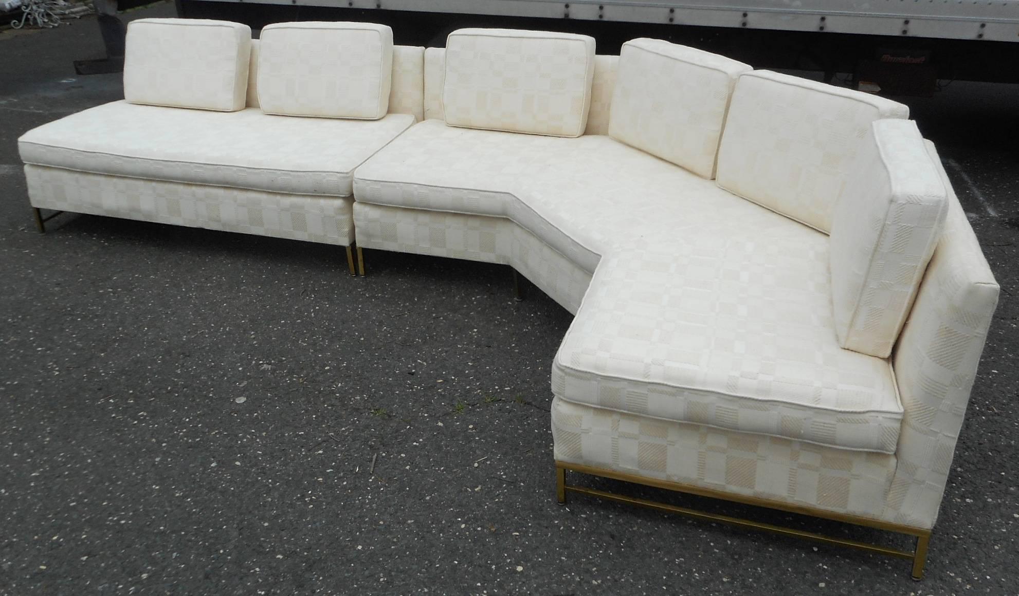 This stunning vintage modern sectional sofa was designed by Paul McCobb for Directional in 1958. Beautiful two-piece design with thick padded cushions and a stylish brass frame. This shapely piece wraps around at the perfect angle ensuring easy