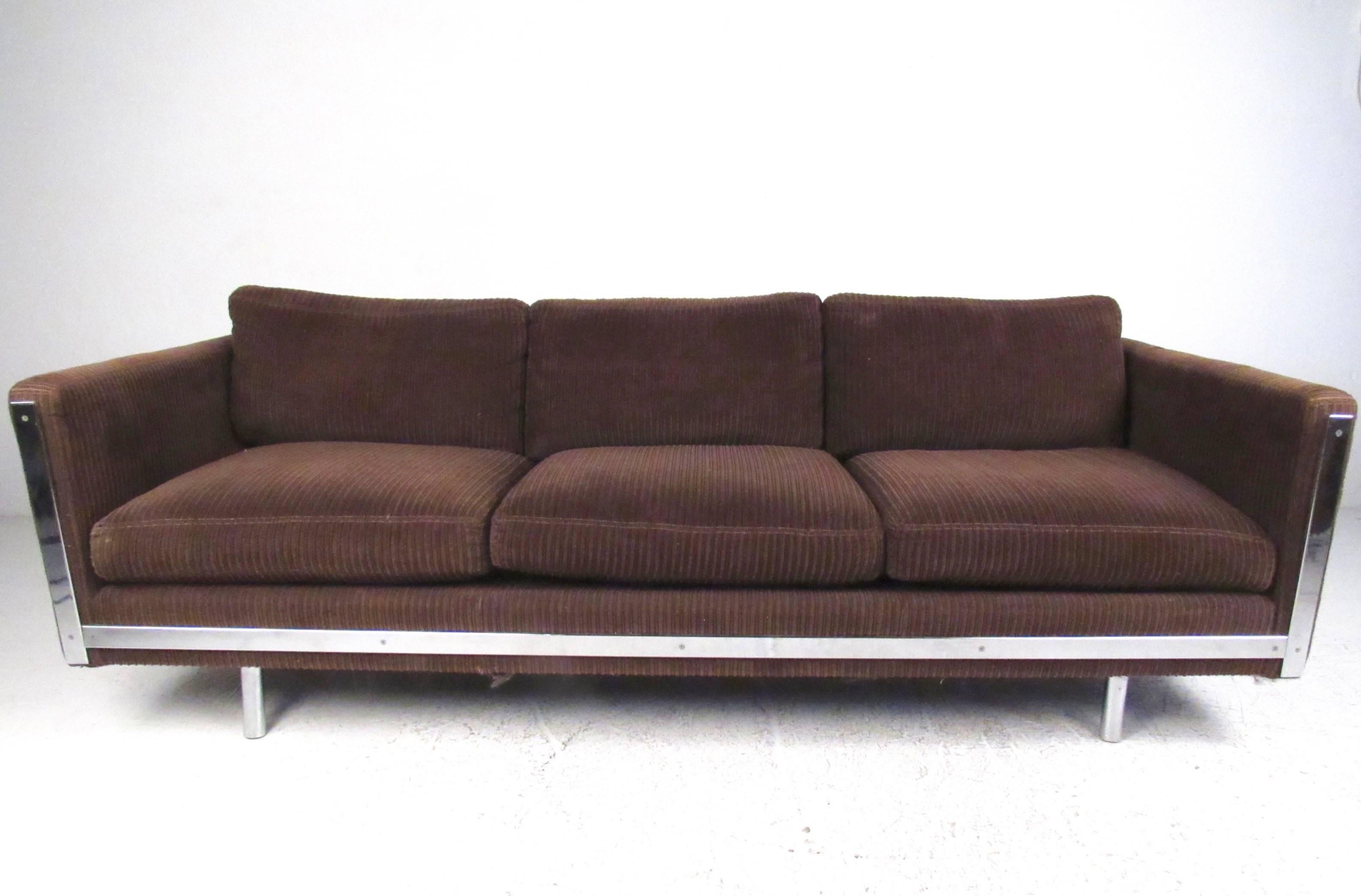 This unique modern three-seat sofa features brown upholstery, comfortable seating, and stylish chrome details. Impressive sofa seating for home or business, please confirm item location (NY or NJ).