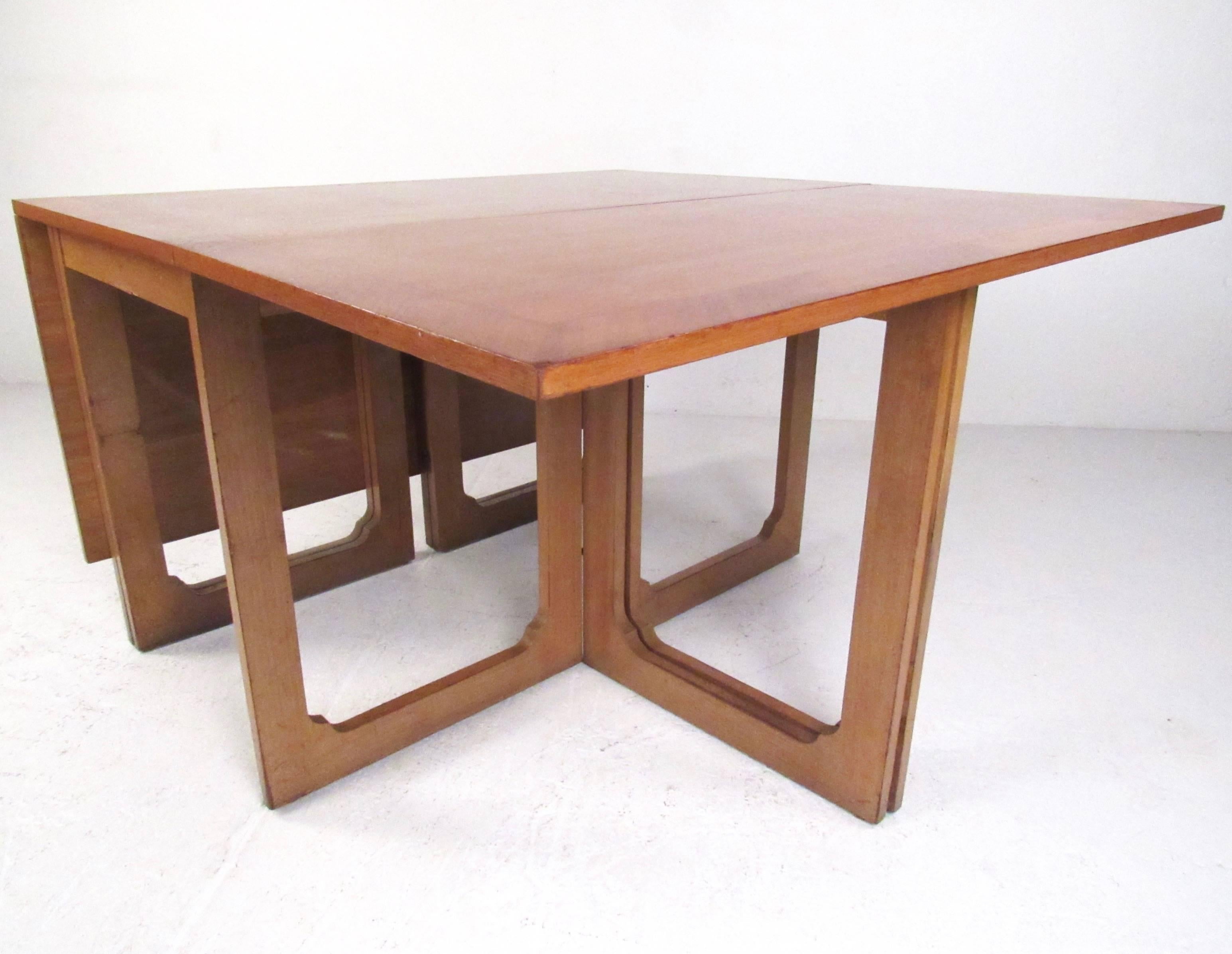 Unique vintage drop leaf dining table mixes versatile gate leg design with timeless Scandinavian Modern appeal. The versatility of this Mid-Century teak table make it the perfect addition to rooms where space is precious, offering expandable seating