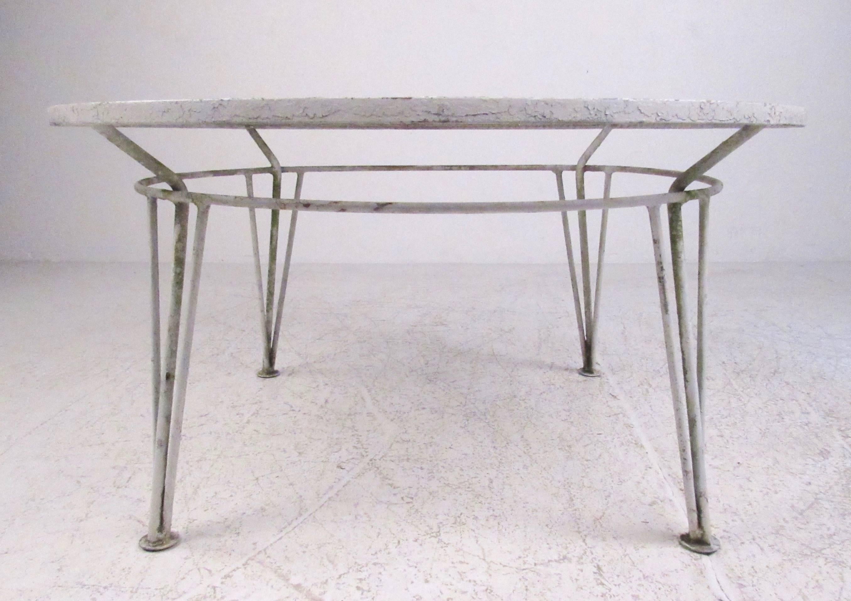 This unique mid-century modern cast iron coffee table features stylish hairpin legs, circular shape, and Salterini style design. This vintage table makes an impressive vintage addition to indoor or outdoor setting. Please confirm item location (NY