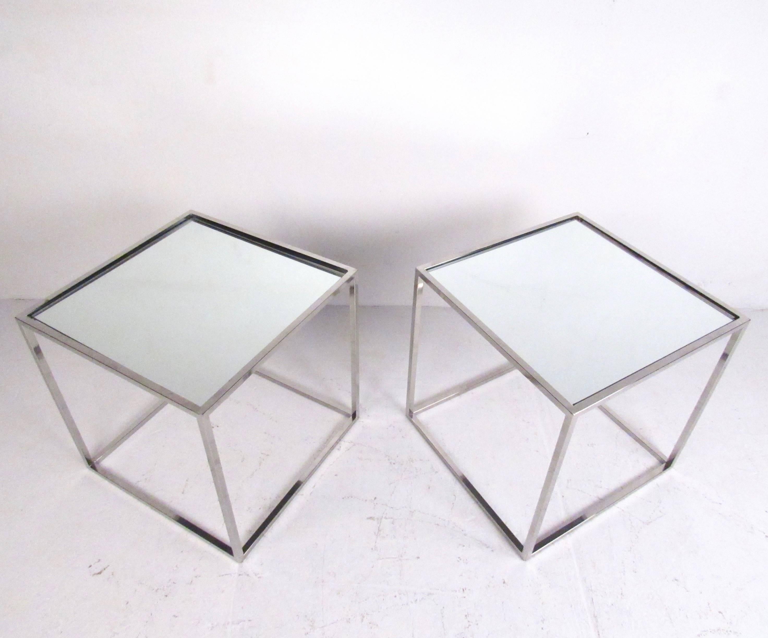This stylish pair of mirrored top end tables feature cube chrome frames in the style of Mid-Century designer Milo Baughman. The clean modern lines of the matching set make them the perfect side tables for any setting. Please confirm item location