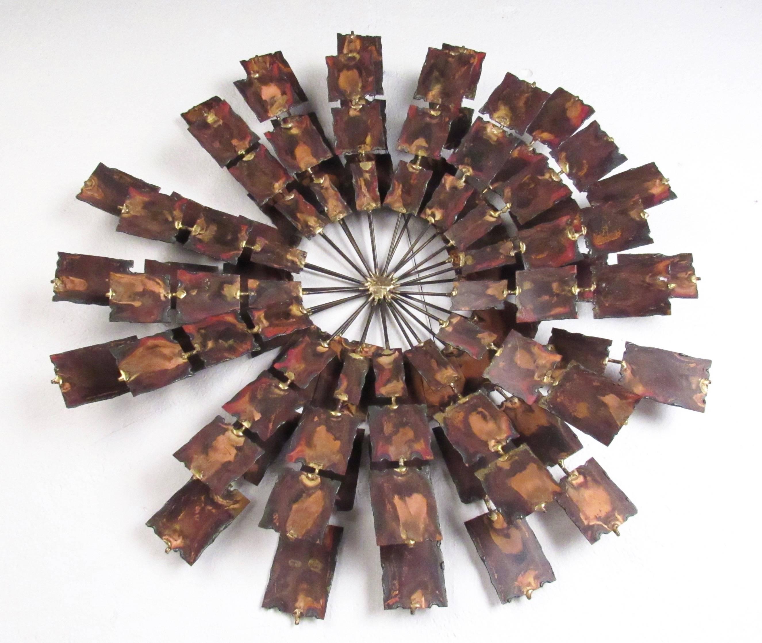 This stylish sunburst style wall art features hammered metal in a circular design after the Mid-Century style of Curtis Jere. Unique mixed metal construction adds to the vintage modern appeal of the piece, impressive wall art for home or business.