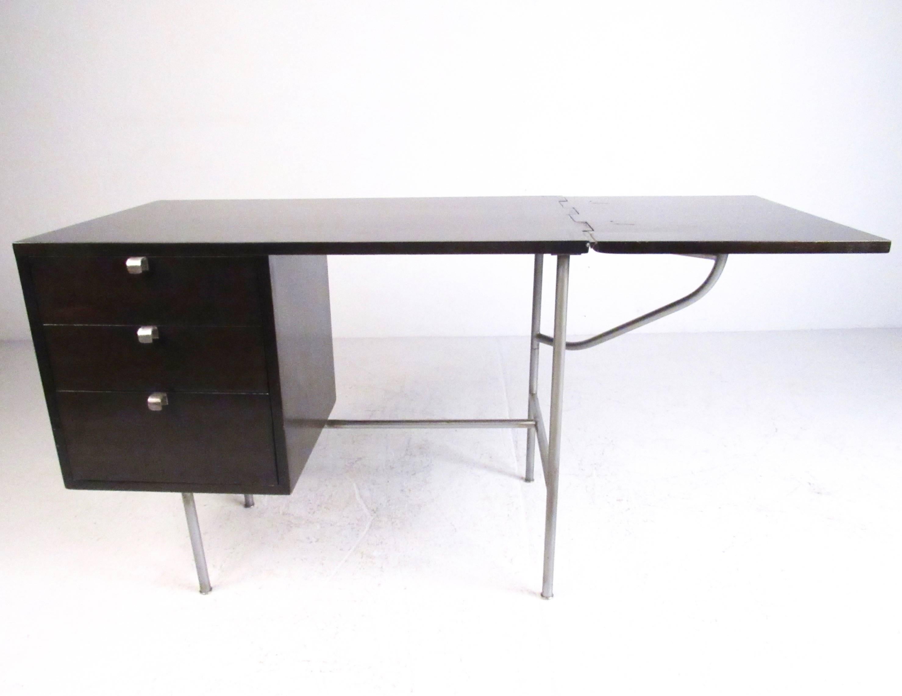 This stylish black lacquered writing desk by George Nelson features stylish modern lines, iconic curved drawer pulls, and the original manufacturers label. Sturdy aluminium frame allows for sturdy Expansion of the workspace via the seventeen inch