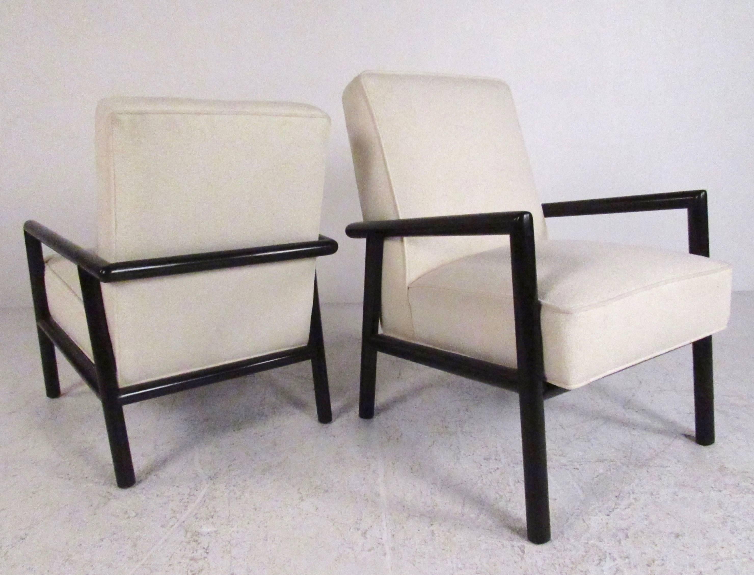 This unique pair of his and hers chairs feature upholstered seats with simple yet shapely black lacquer frames. Exquisite modern design by T.H. Robsjohn-Gibbings makes a striking impression in any seating arrangement for home or office. Differing