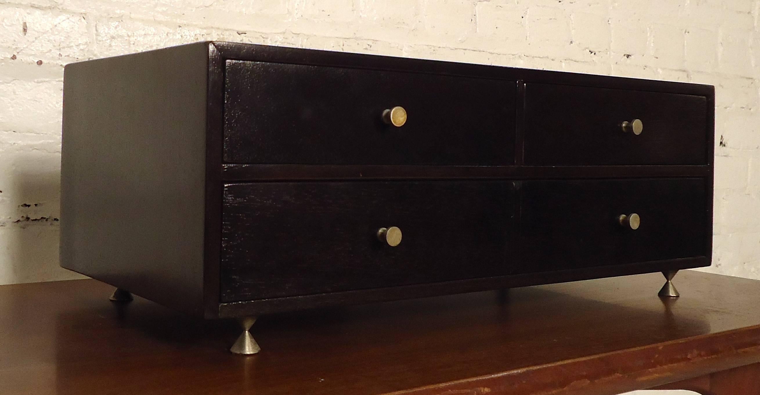 Stylish modernist jewelry box in the manner of Paul McCobb features a deep brown color lacquer finish, two top drawers, one wide bottom with dividers, chrome handles and legs.

Please confirm item location (NY or NJ).