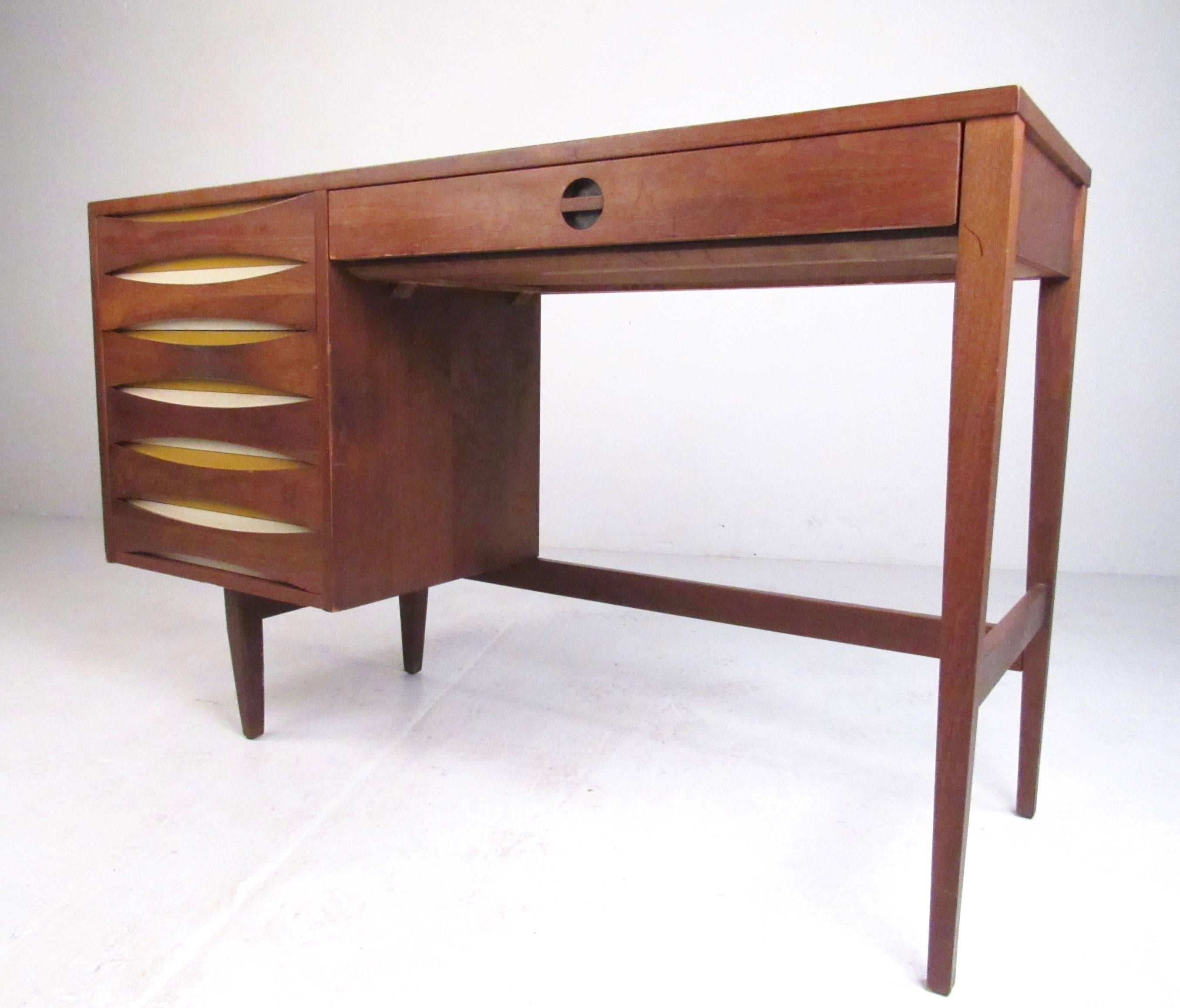 This stylish vintage modern bedroom suite includes four stunning pieces, finished in vintage walnut with unique Arne Vodder style drawer fronts. Matching low dresser, highboy, nightstand, and writing desk make an impressive Mid-Century Modern