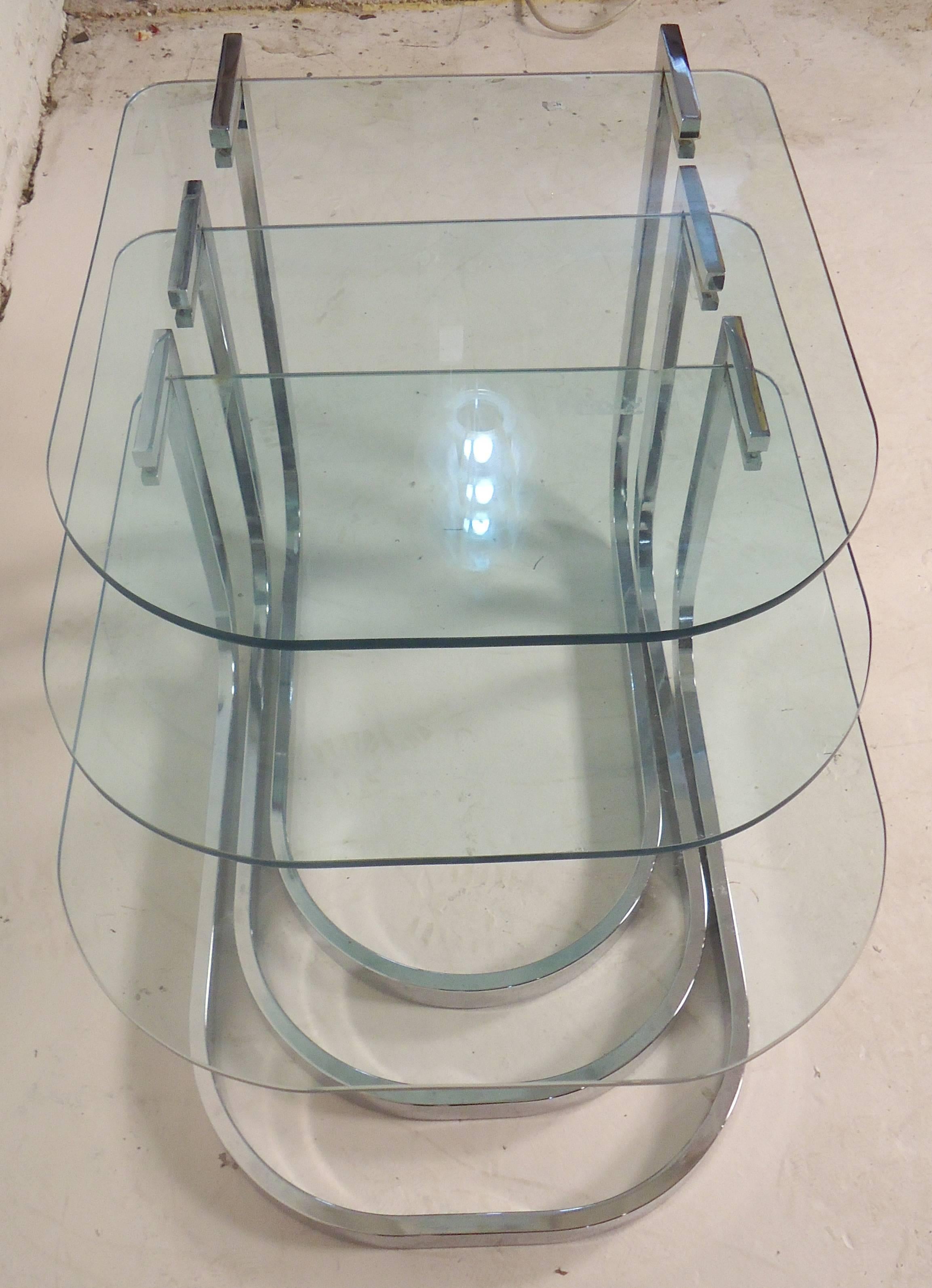 Set of three polished chrome tables with glass inserts. Mid-Century Modern shape and style.

(Please confirm item location - NY or NJ - with dealer).
 
