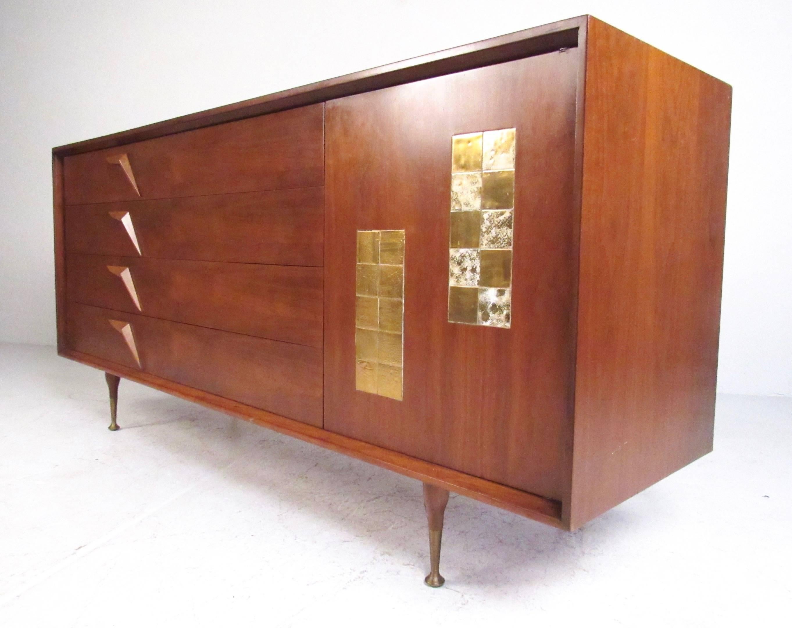 This unique 1950s bedroom dresser features all the design details of a high quality mid-century American piece. Stunning sculpted walnut drawer pulls, unique inlaid tile motif, tapered legs with quality brass sabots, along with metal drawer glides