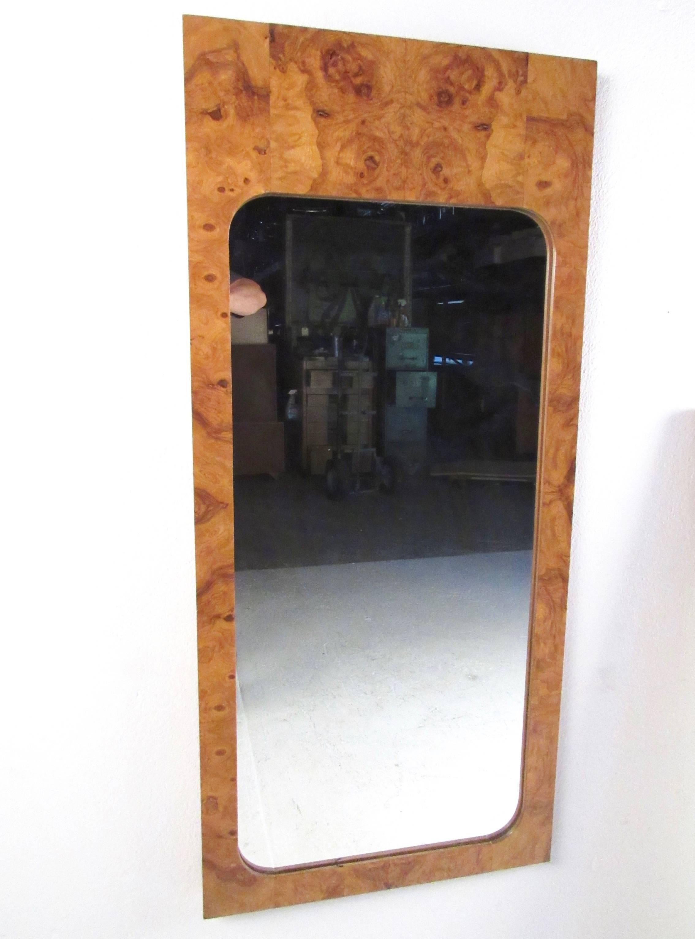 This stylish pair of Mid-Century Modern mirrors feature a golden burl finish and modern lines. Great pair of mirrors for bedroom, living room, or office. Matched pair of Lane Furniture mirrors designed by Milo Baughman. Please confirm item location