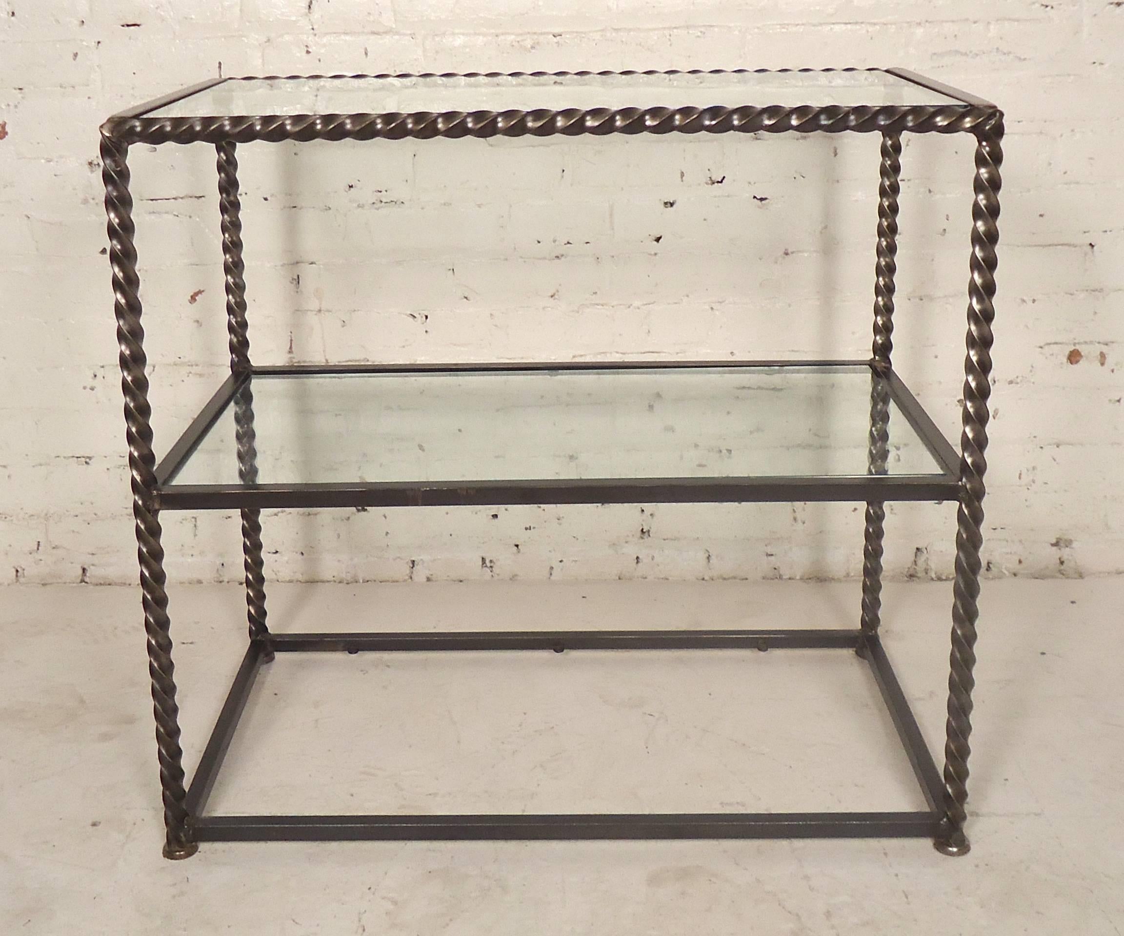 Heavy metal table with glass, featuring a handsome Industrial bare metal style finish. Three glass shelves can be placed. Great for entry way or as a standing bar.

(Please confirm item location, NY or NJ, with dealer).
 