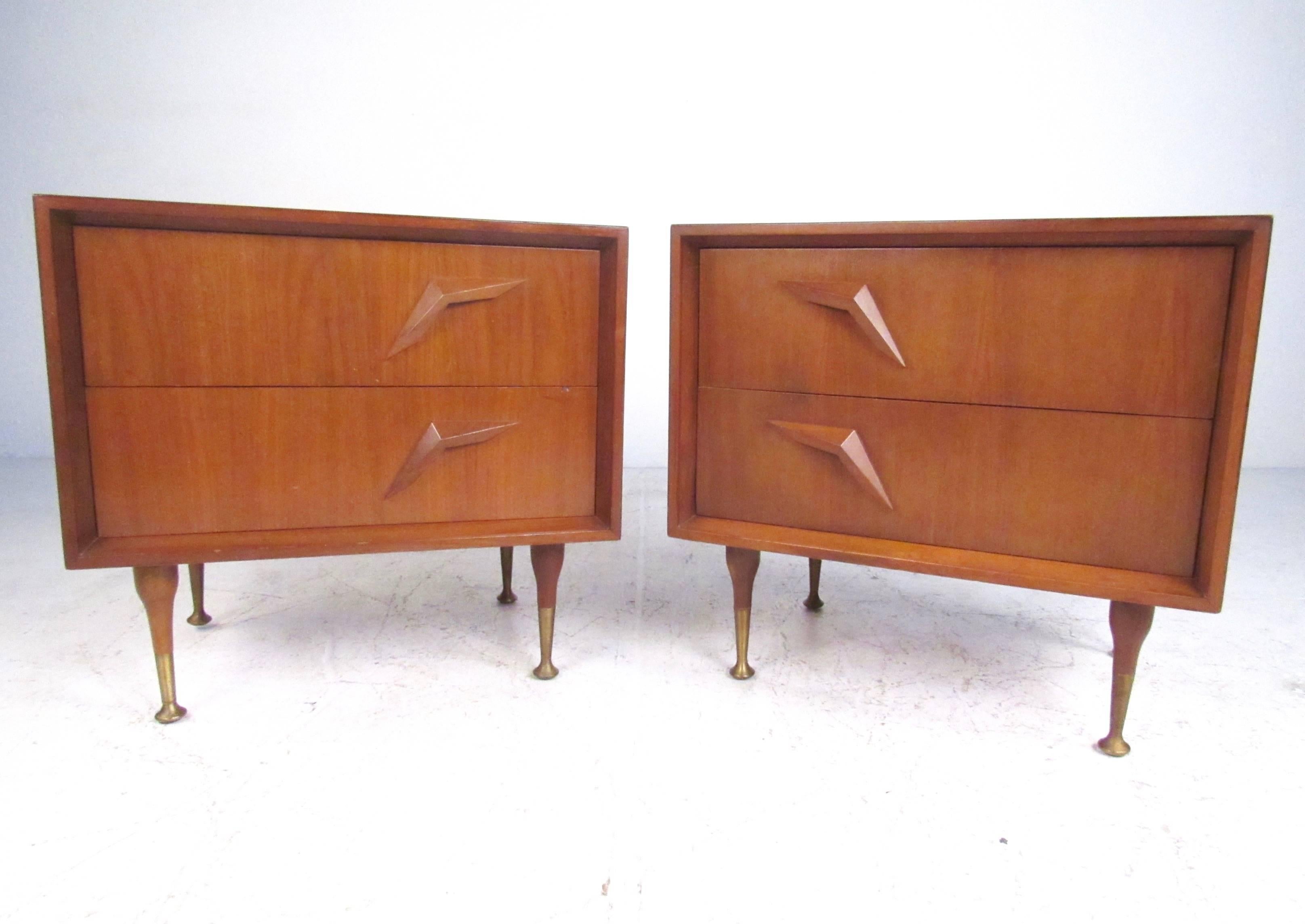 This gorgeous pair of two-drawer nightstands feature tapered legs, brass sabots, and unique sculpted drawer pulls. The stylish Mid-Century Modern appeal of this matching pair of end tables makes them an impressive addition to any bedroom. Matching