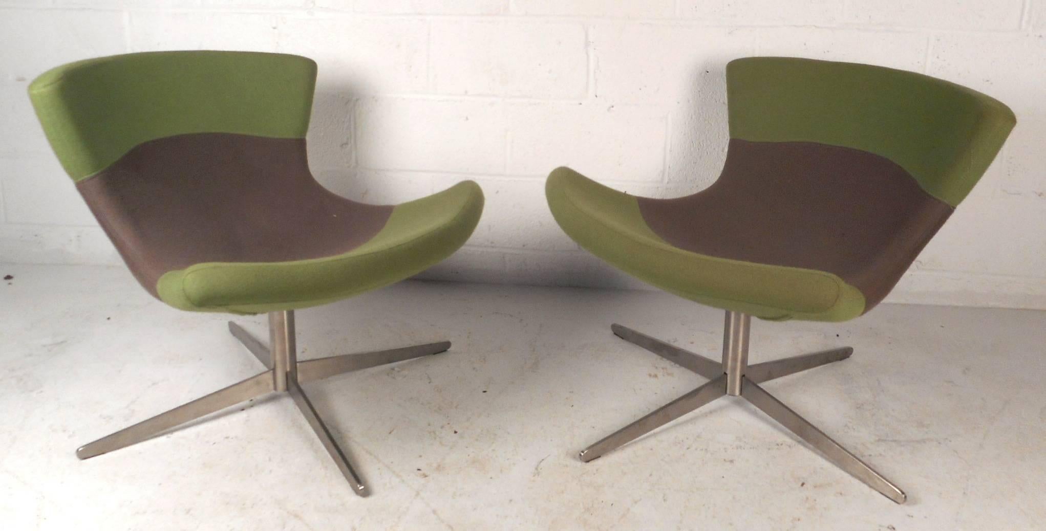 This beautiful pair of vintage modern lounge chairs feature sculpted seating with a winged backrest. Sleek design with colorful plush upholstery and a heavy chrome swivel base. Unique chairs with the perfect contours and thick padded seating to