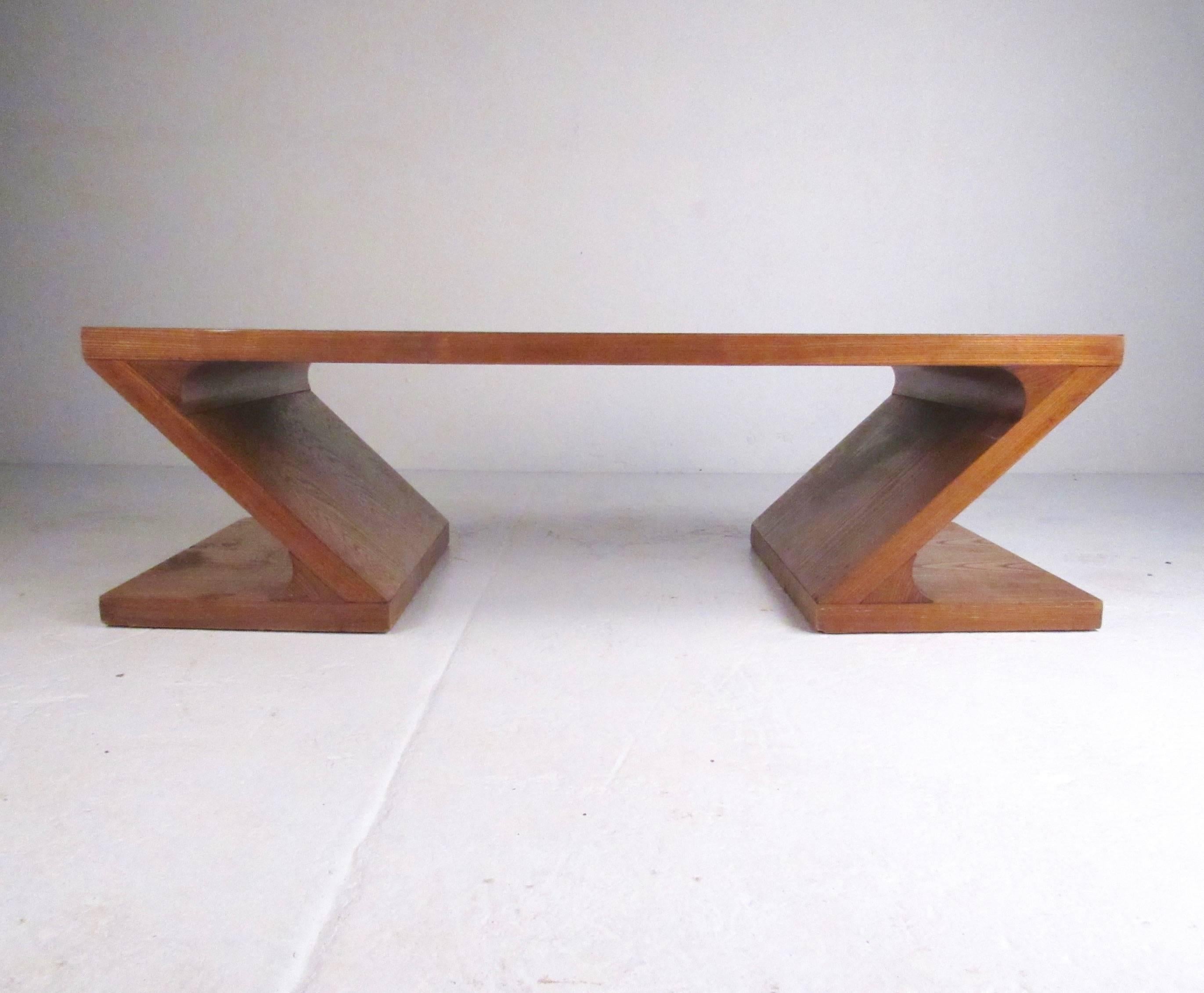 This uniquely shaped vintage modern coffee table by Lane features two-tone oak marquetry with stylish Z type design. The vintage modern appeal of the coffee table makes it an impressive addition to any seating area. Pair of matching end tables also