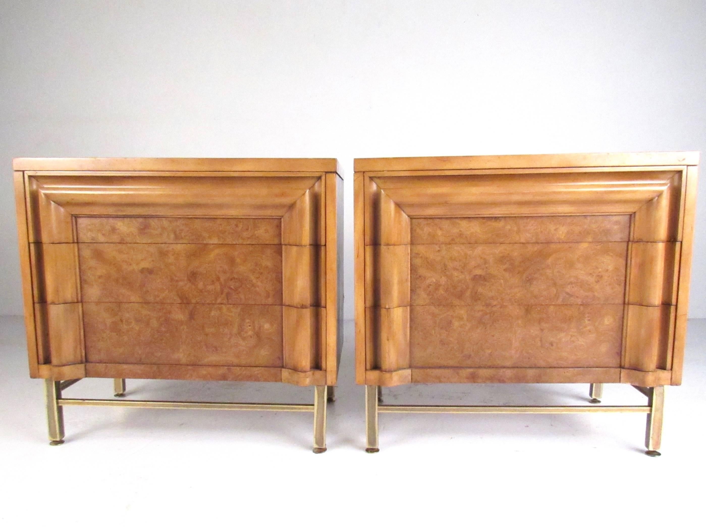 This pair of three-drawer burl wood nightstands feature brass finish legs, two-tone cherry burl wood finish, and offers plenty of storage for bedside use. Quality Mid-Century American construction makes these an impressive addition to any interior.