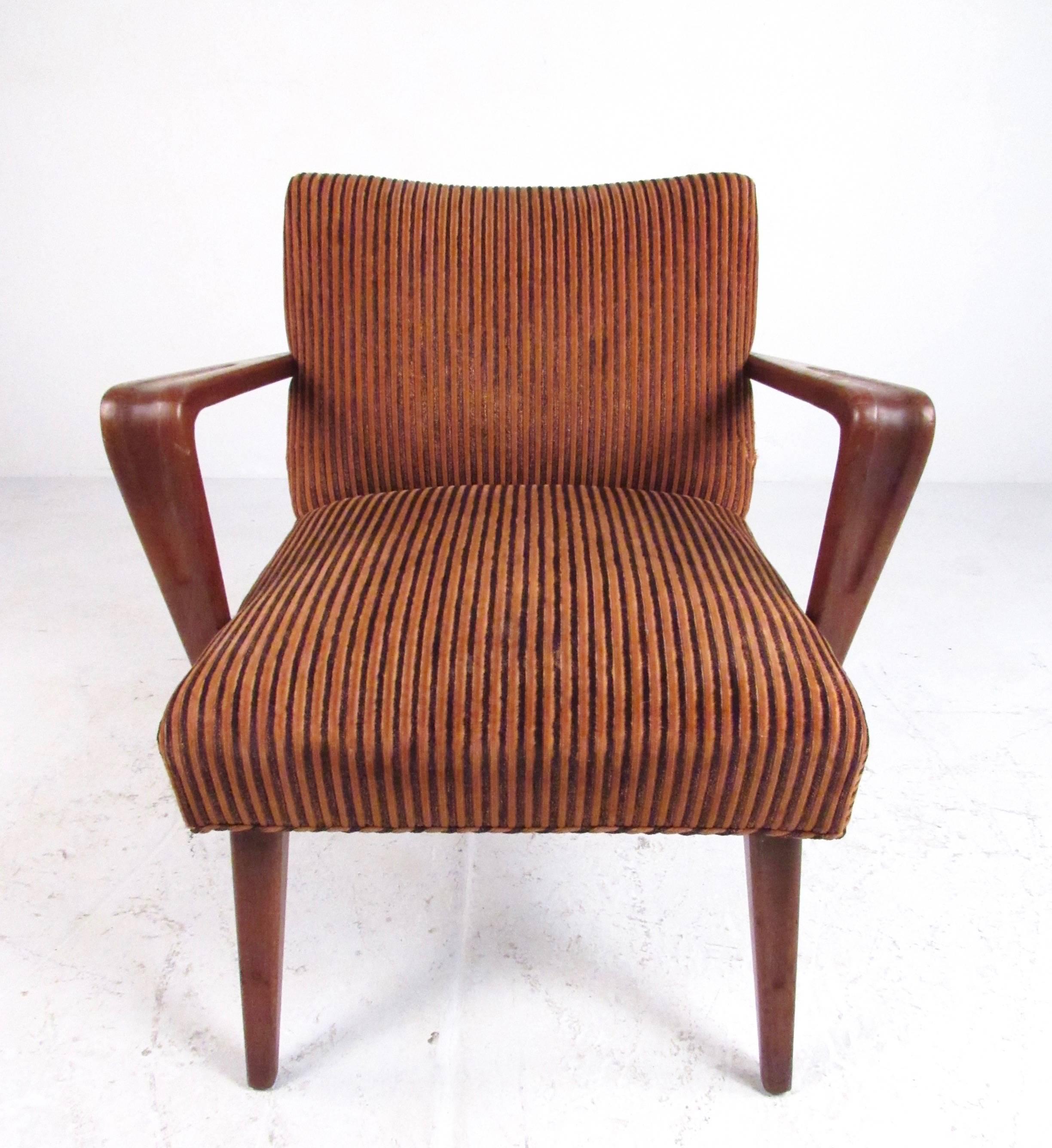 This unique Mid-Century Modern armchair features stylish tapered legs, sculptural arm rests, vintage modern fabric, and comfortable shapely design. This petite side chair makes an excellent seating option in any interior, please confirm item