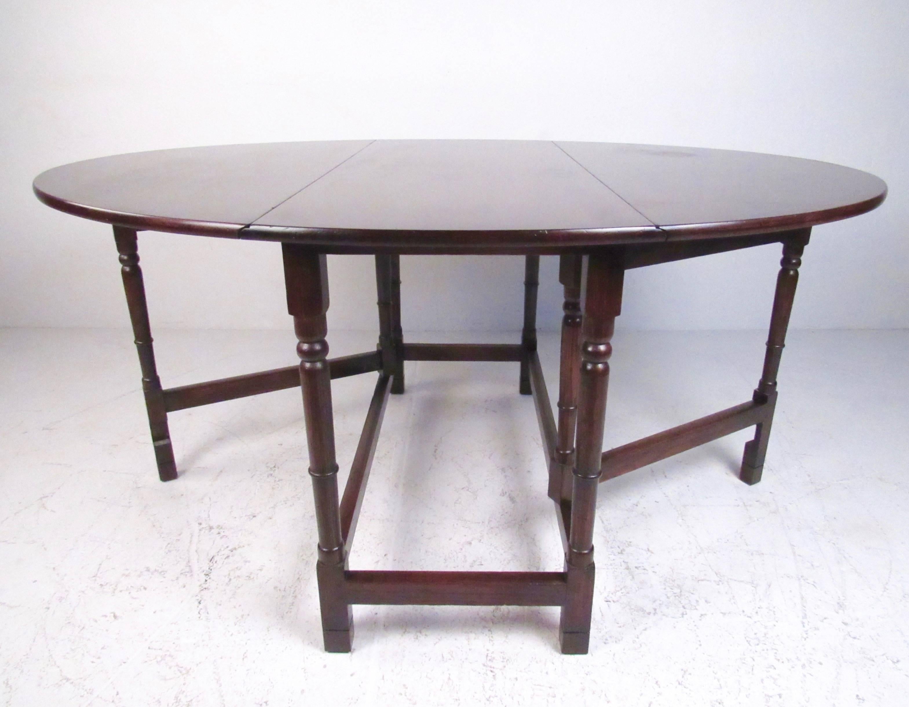 This stylish vintage modern table features sculpted gate leg base with spacious drop leaf tabletop. Expanding easily from 22 inches wide to 54 wide, this oval dining table makes a stately impression in any interior. Wonderful vintage patina with