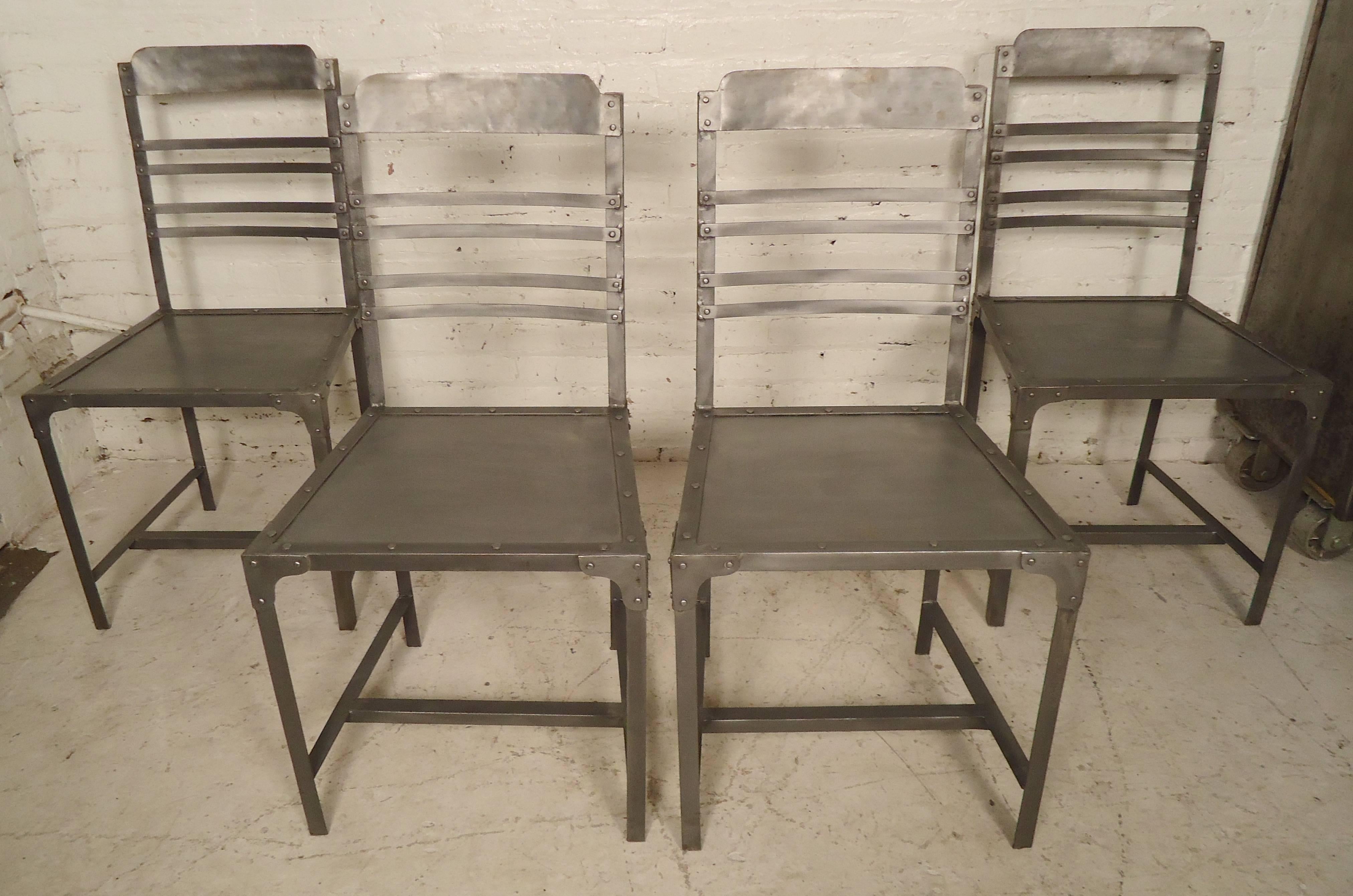 Handsome set of metal chairs in an Industrial style finish. Features exposed nailheads and slat backs.

(Please confirm item location - NY or NJ - with dealer).
 