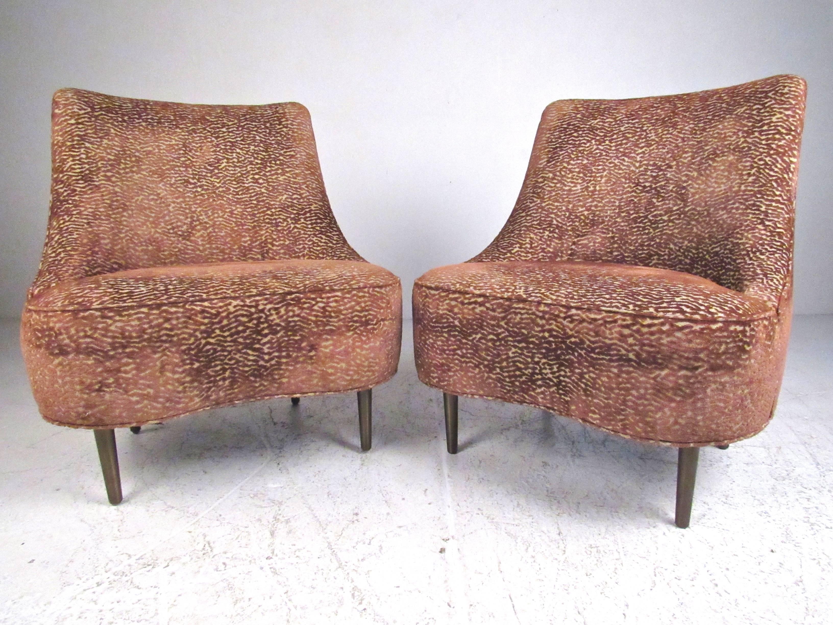 This stylish pair of Mid-Century Modern lounge chairs feature stylish slipper design by iconic designer Edward Wormley for Dunbar. Bronze finish metal legs make a unique statement while the shapely upholstered seat backs make for a comfortable