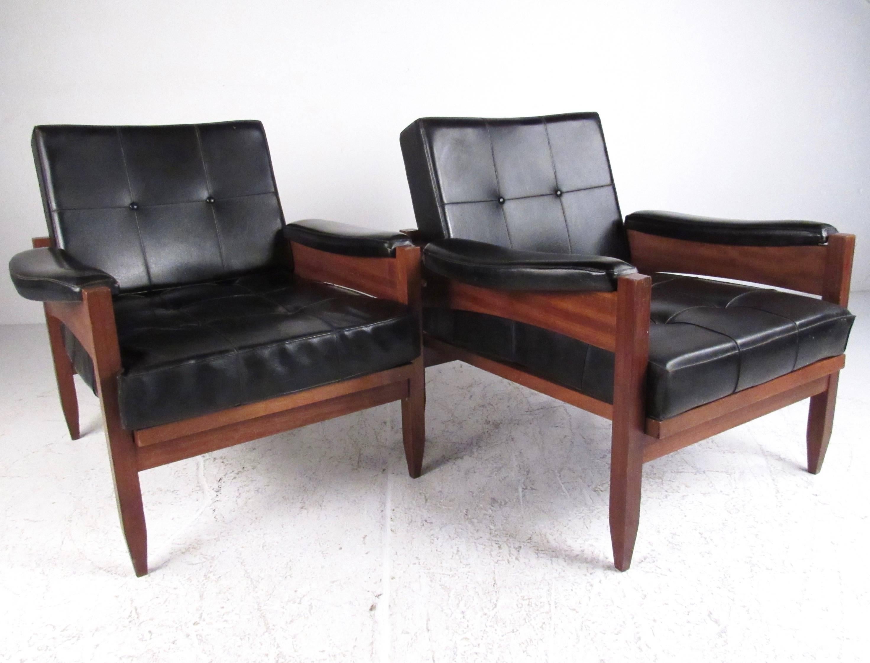 This stylish pair of Mid-Century club chairs features tufted vinyl upholstery with sturdy teak frames. The Scandinavian design cues on this vintage pair of chairs add distinction to any setting, in addition to offering impressive comfort and classy