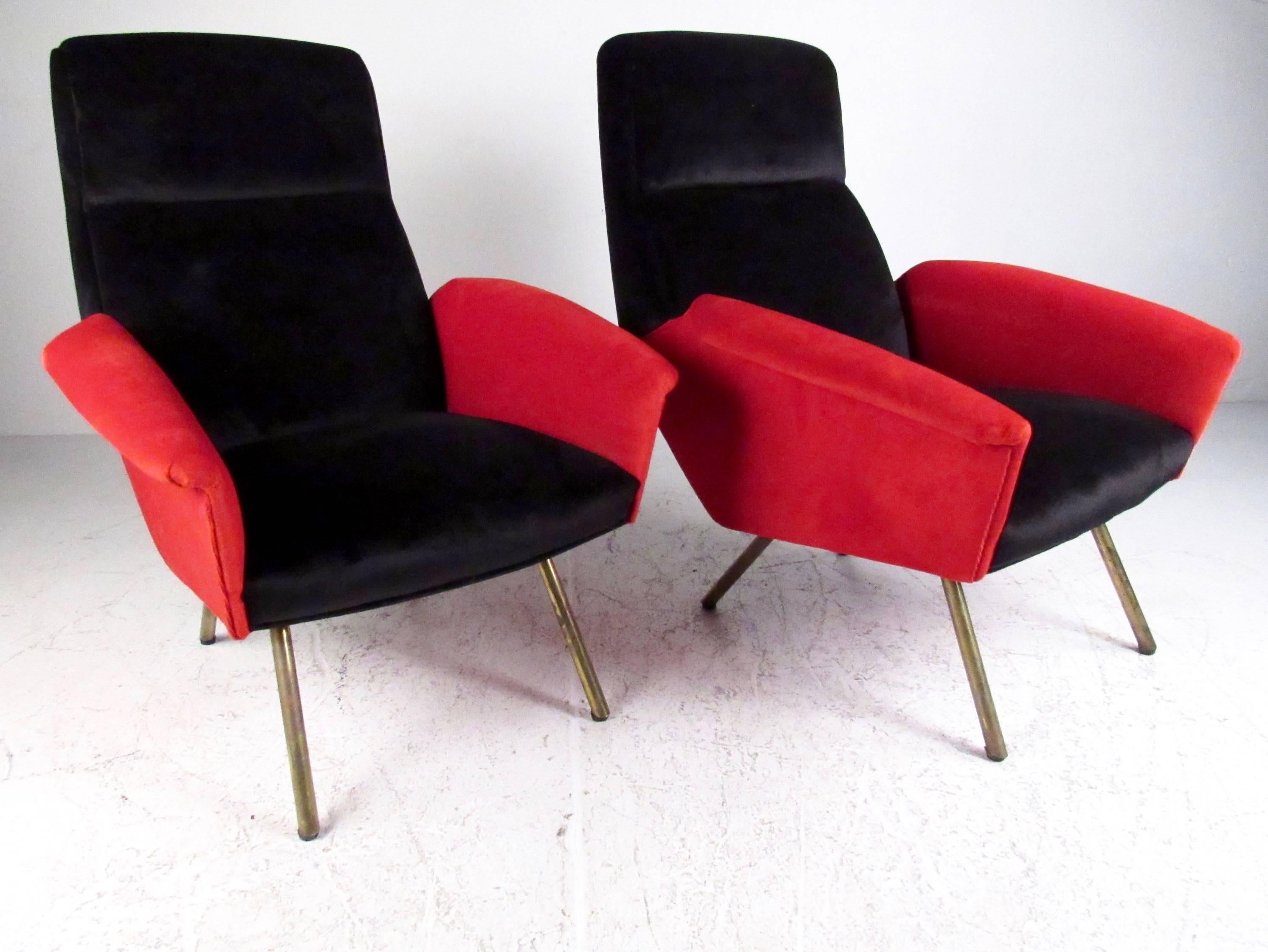 This uniquely sculpted pair of contemporary modern lounge chairs feature stylish Italian design, comfortable upholstered seats, and brass finish legs. Unique red and black fabric adds to the impressive visual statement of the pair, making them a