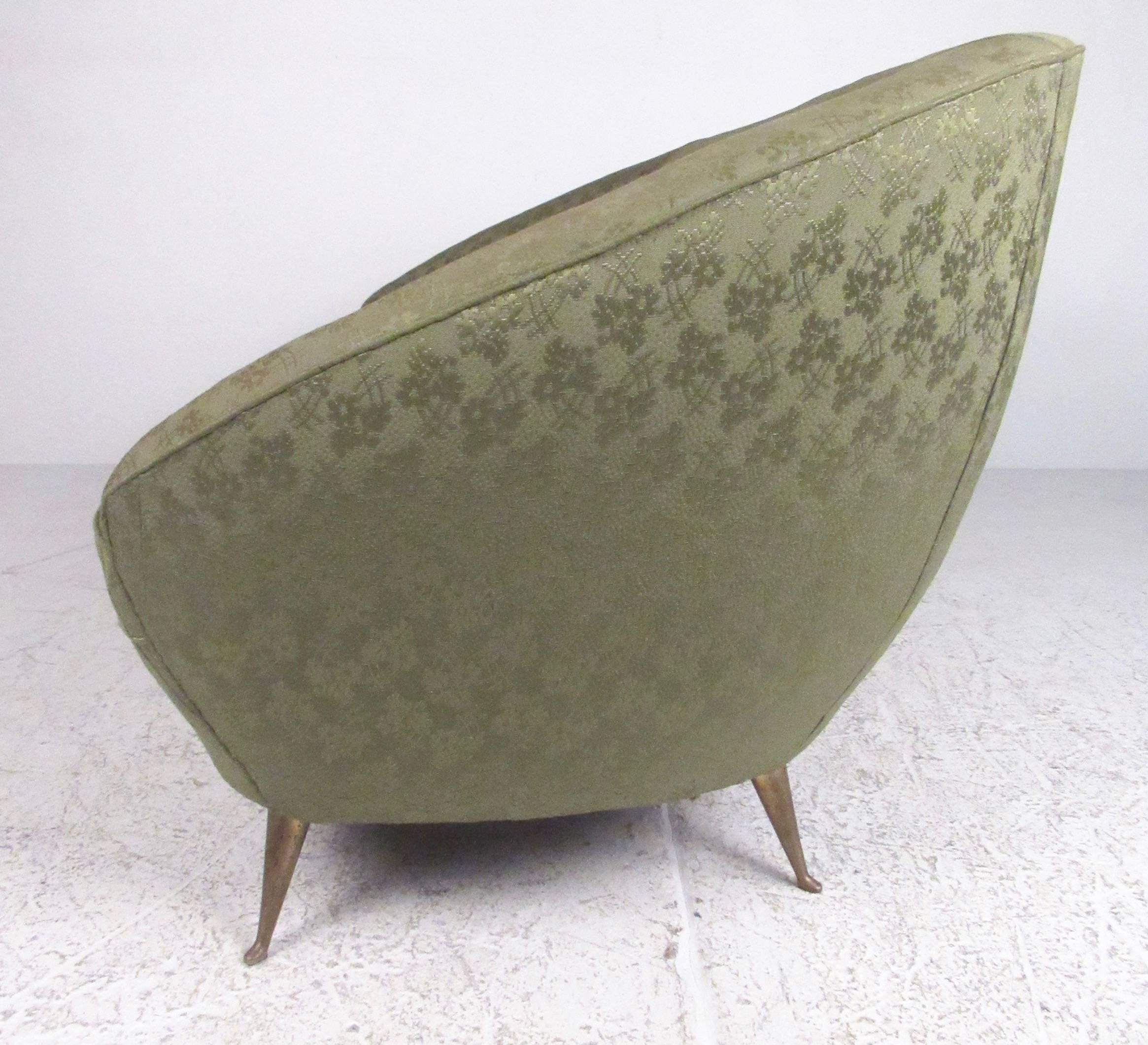 This stylish vintage modern love seat features unique vintage fabric, shapely rounded seat back, and tapered brass legs. The comfortable design of this Italian Modern sofa makes an impressive seating addition to any interior. Please confirm item