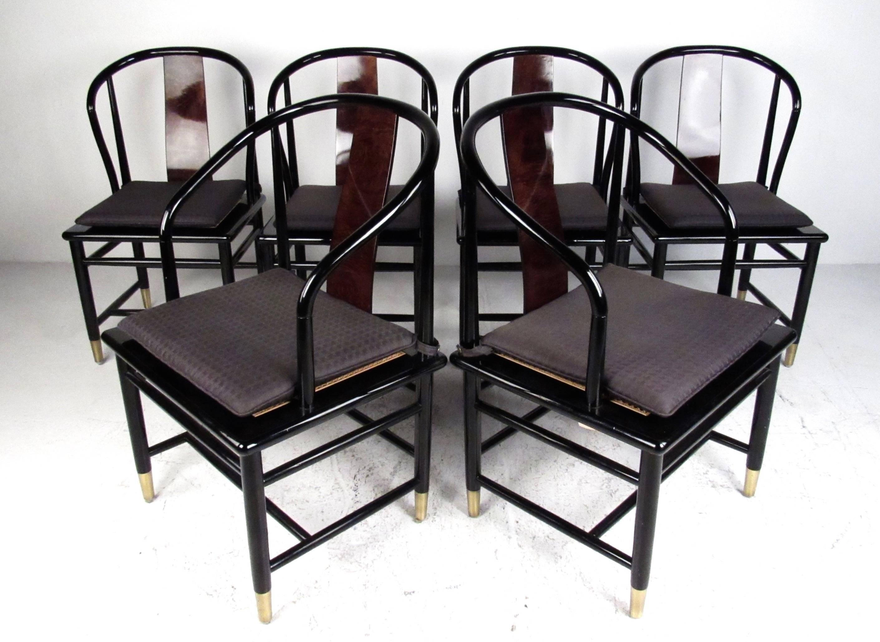 This unique set of six dining chairs features black lacquer frames with comfortable rounded seat backs, boasting a lacquered burl seat back and cane seat. Brass sabots nicely compliment the dark finish of the set, while removable cushions allow some