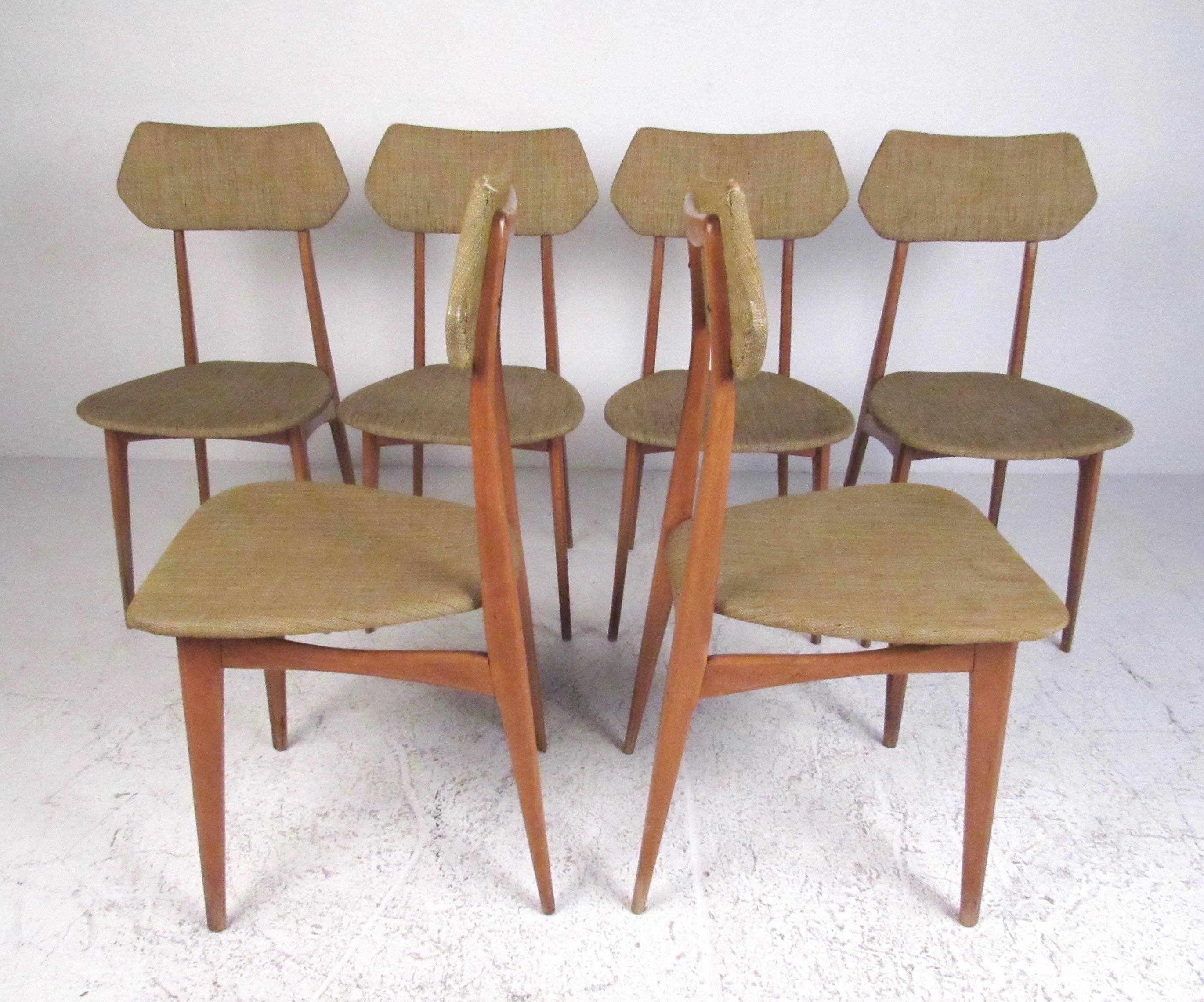 This sleek and stylish set of six vintage modern dining chairs feature sculptural Italian modern design in the style of Ico Parisi. Slender tapered legs and comfortable sculpted seats make the matching set of six an impressive addition to any dining