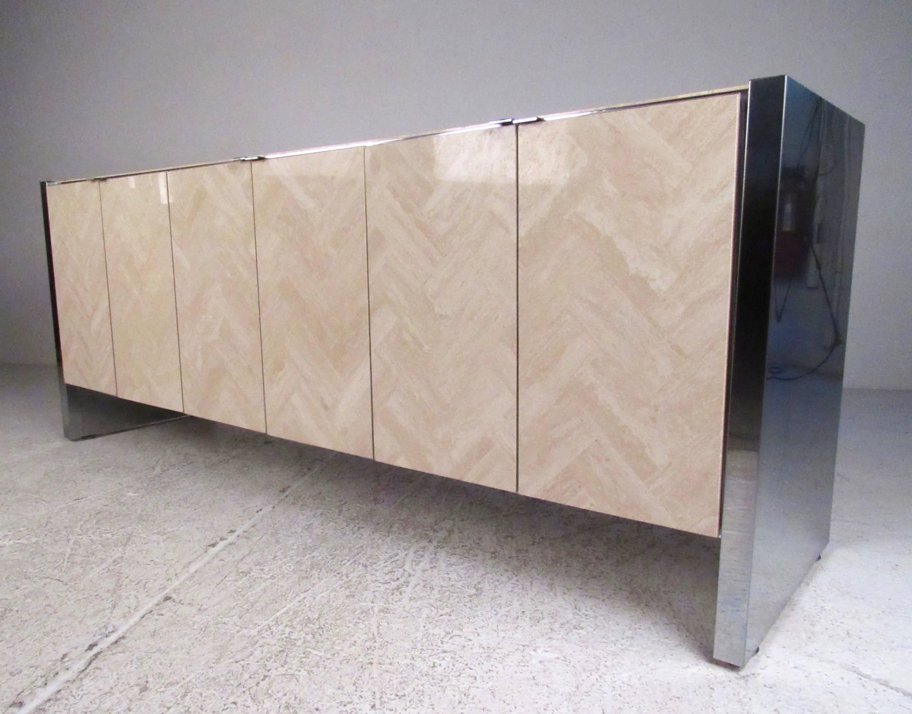 This stylish vintage credenza features impressive travertine finish matched with vintage Ello style chrome trim. Spacious interior cabinets offer plenty of office or dining room storage without sacrificing style. Mid-Century Modern sideboard perfect